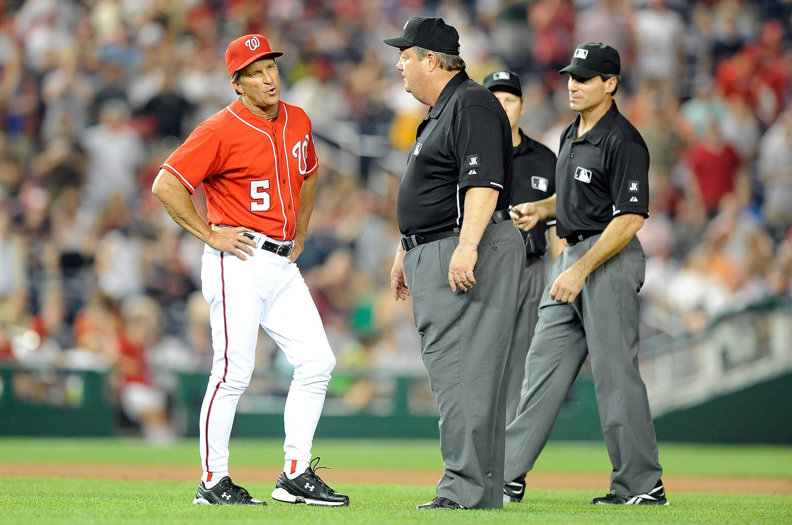 WASHINGTON - JUNE 04: Manager Jim Riggleman of the Washington Nationals argues with first base umpire Joe West, second base umpire Angel Hernandez and third base umpire Paul Schrieber after a call in the seventh inning of the game against the Cincinnati WASHINGTON - JUNE 04: Manager Jim Riggleman of the Washington Nationals argues with first base umpire Joe West, second base umpire Angel Hernandez and third base umpire Paul Schrieber after a call in the seventh inning of the game against the Cincinnati