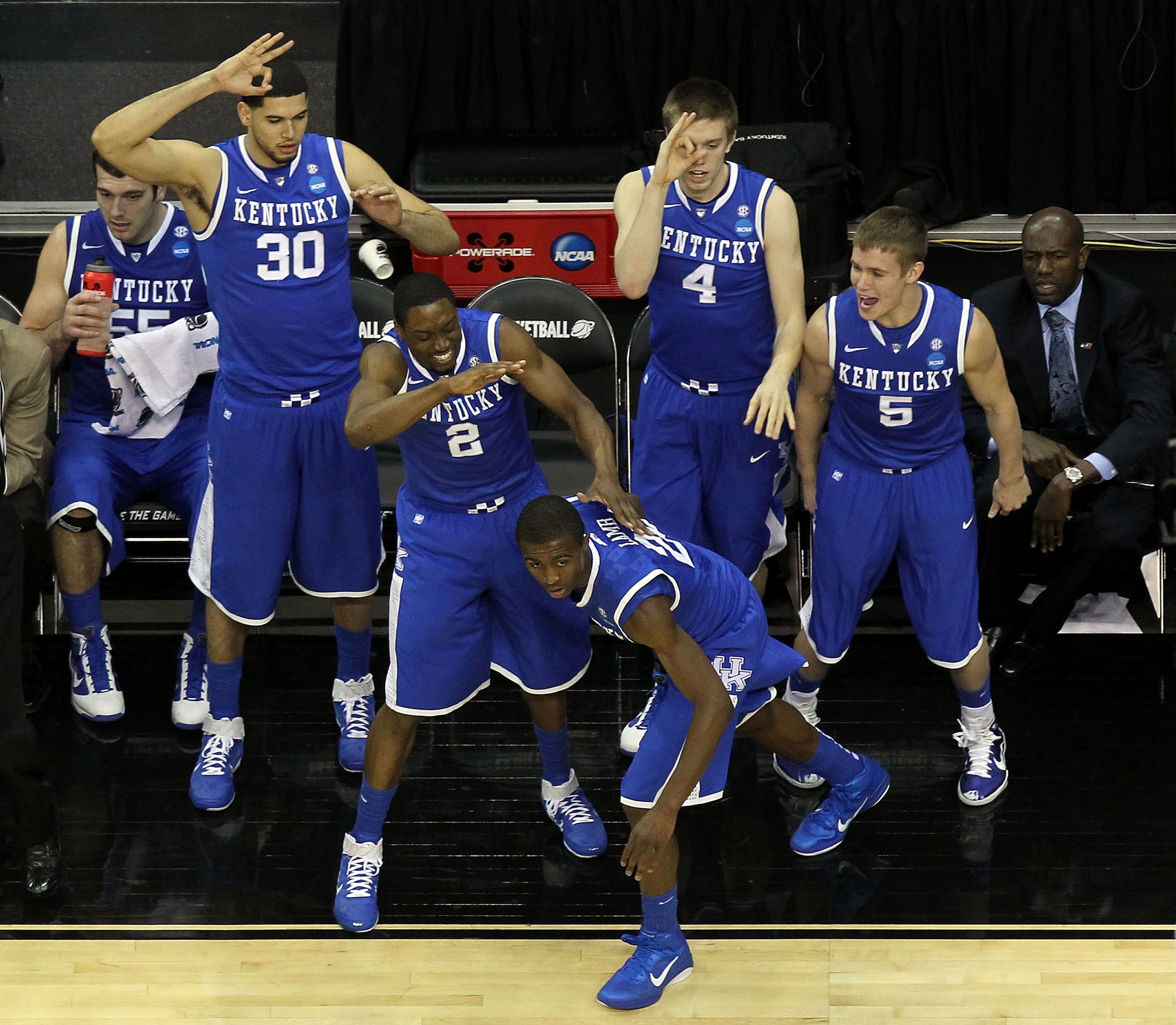 NEWARK, NJ - MARCH 25:  Eloy Vargas #30, Stacey Poole Jr. #2, Doron Lamb #20 Jon Hood #4 and Jarrod Polson #5 of the Kentucky Wildcats celebrate from the bench after play against the Ohio State Buckeyes during the east regional semifinal of the 2011 NCAA