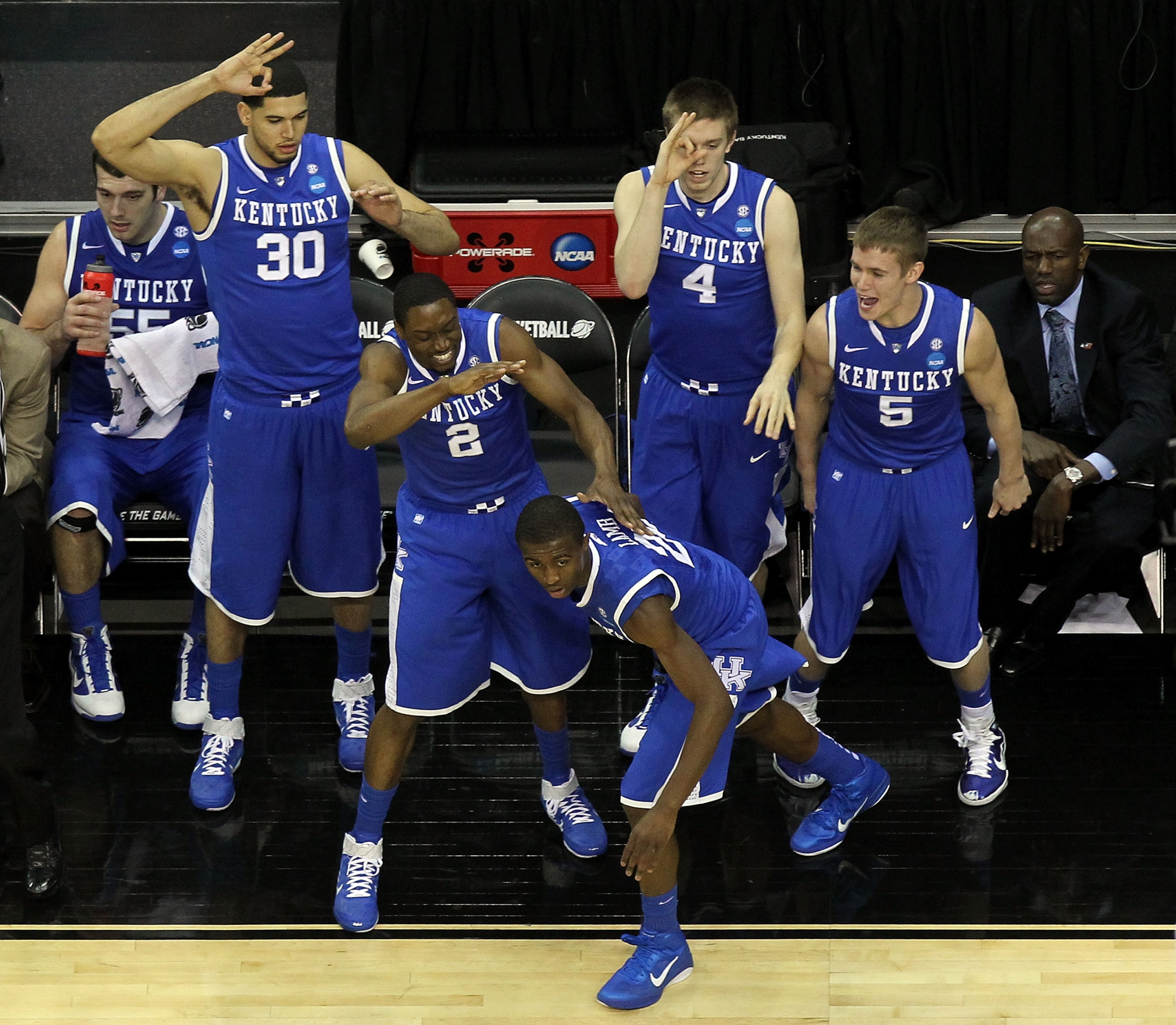 NEWARK, NJ - MARCH 25:  Eloy Vargas #30, Stacey Poole Jr. #2, Doron Lamb #20 Jon Hood #4 and Jarrod Polson #5 of the Kentucky Wildcats celebrate from the bench after play against the Ohio State Buckeyes during the east regional semifinal of the 2011 NCAA