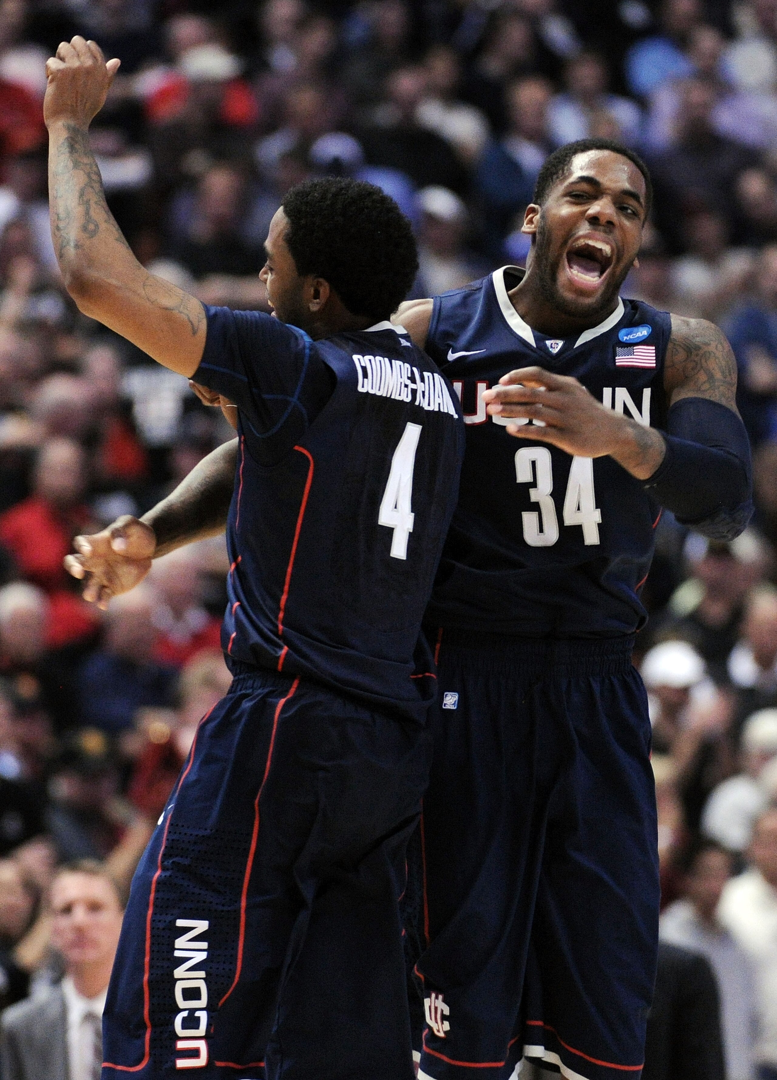 ANAHEIM, CA - MARCH 24:  Jamal Coombs-McDaniel #4 and Alex Oriakhi #34 of the Connecticut Huskies celebrate after defeating the San Diego State Aztecs during the west regional semifinal of the 2011 NCAA men's basketball tournament at the Honda Center on M