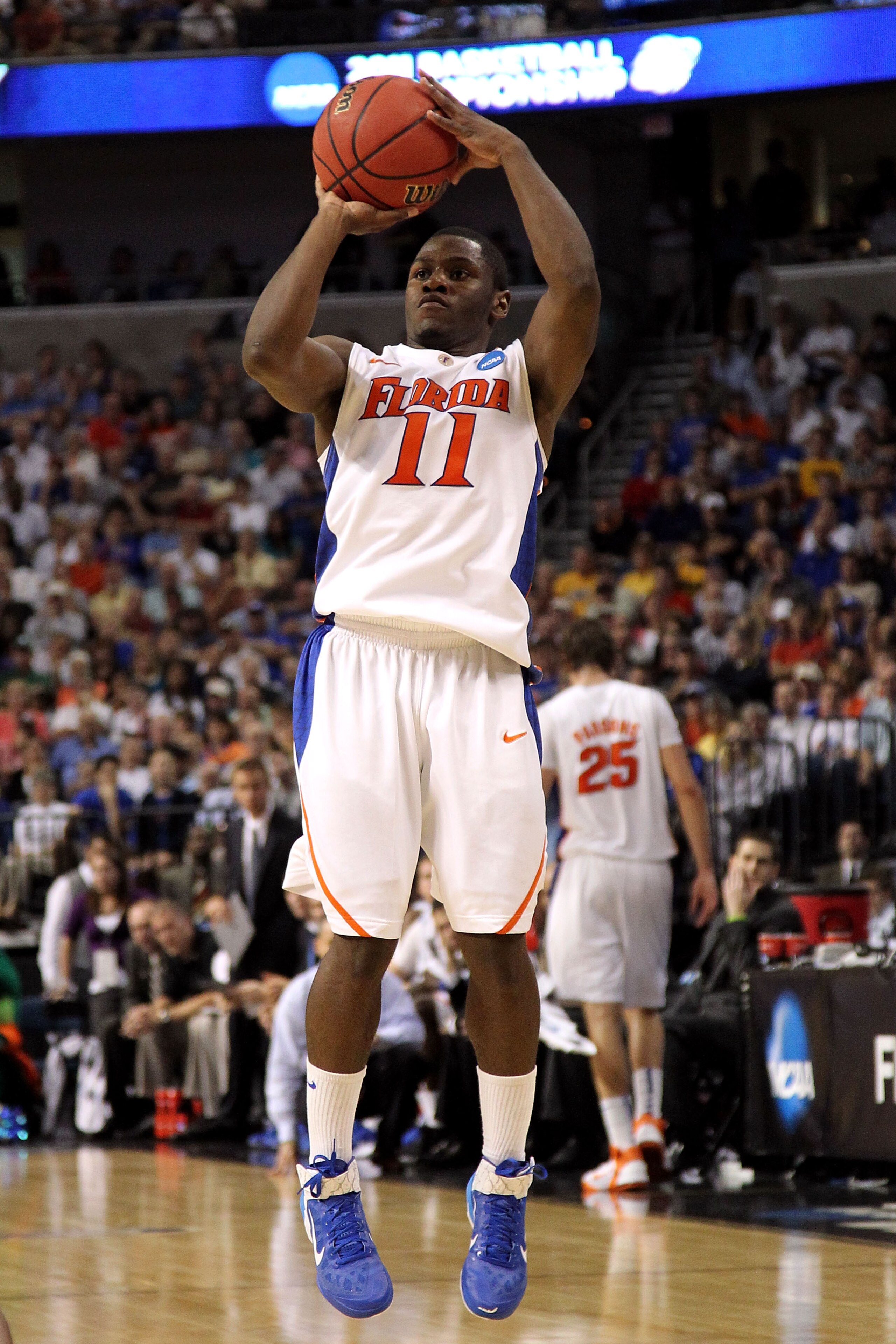 TAMPA, FL - MARCH 19:  Erving Walker #11 of the Florida Gators attempts a shot against the UCLA Bruins during the third round of the 2011 NCAA men's basketball tournament at St. Pete Times Forum on March 19, 2011 in Tampa, Florida. Florida won 73-65. (Pho
