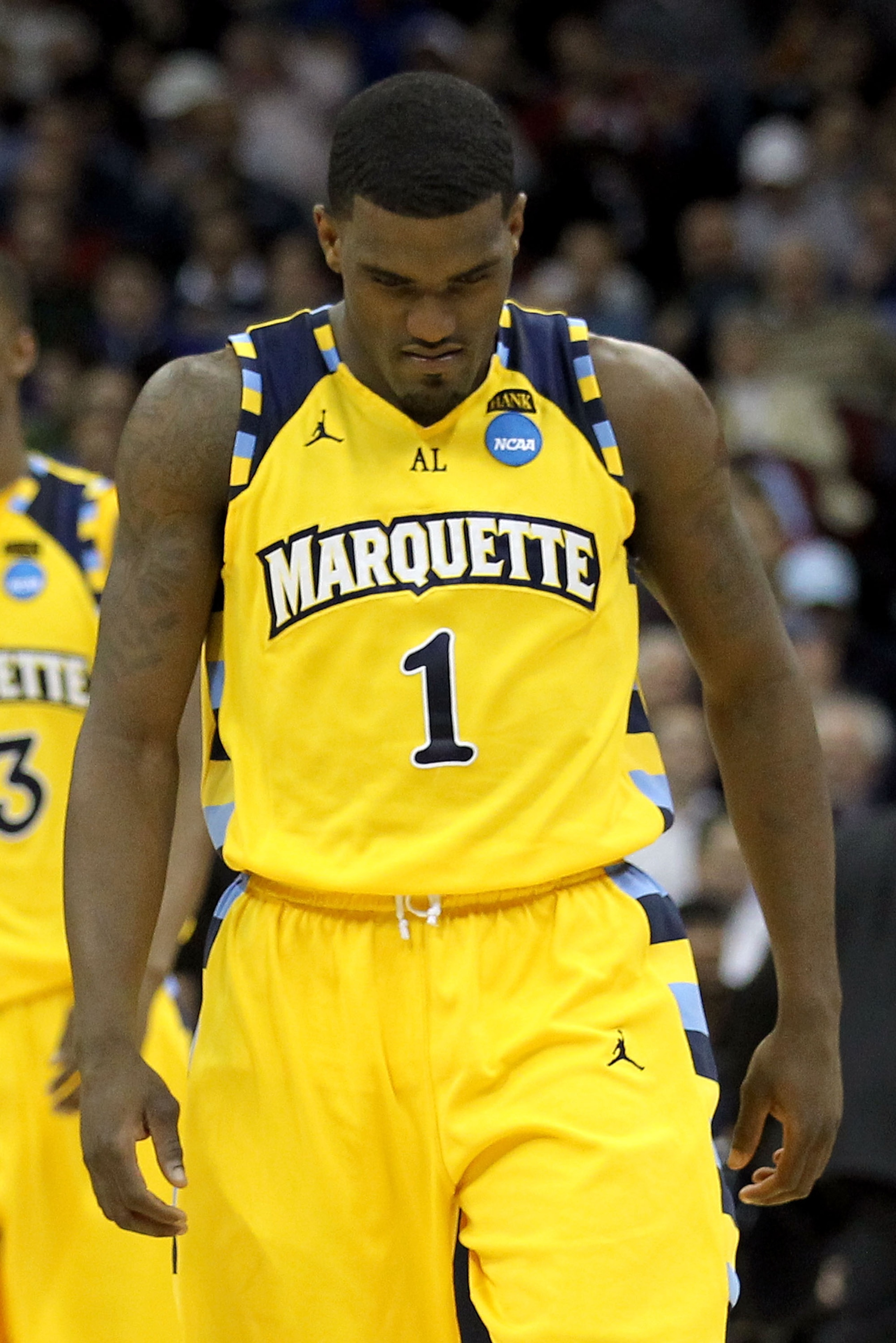 NEWARK, NJ - MARCH 25:  Darius Johnson-Odom #1 of the Marquette Golden Eagles walks away after a play against the North Carolina Tar Heels during the first half of the east regional semifinal of the 2011 NCAA Men's Basketball Tournament at the Prudential