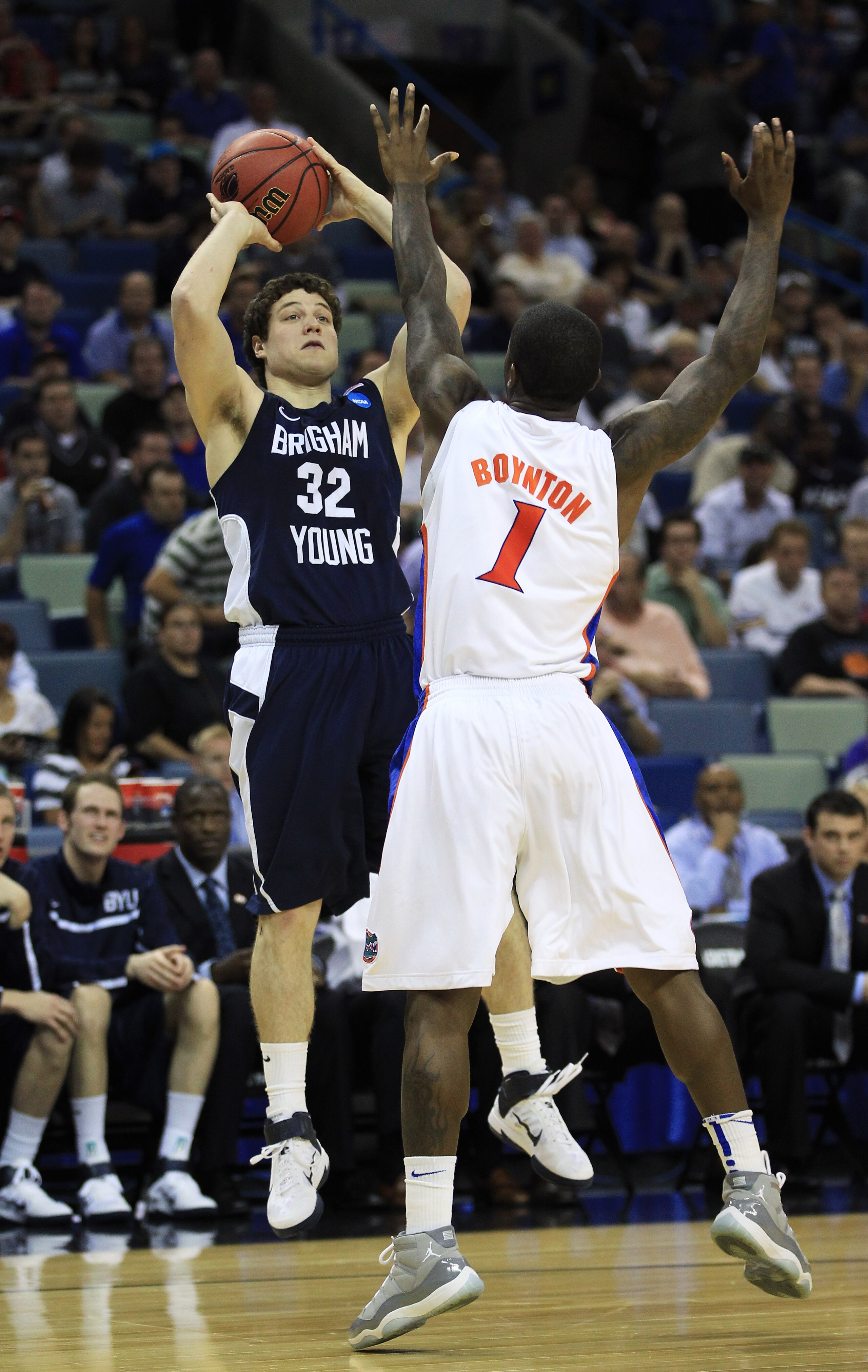NEW ORLEANS, LA - MARCH 24:  Jimmer Fredette #32 of the Brigham Young Cougars shoots over Kenny Boynton #1 of the Florida Gators in the second half during the Southeast regional of the 2011 NCAA men's basketball tournament at New Orleans Arena on March 24