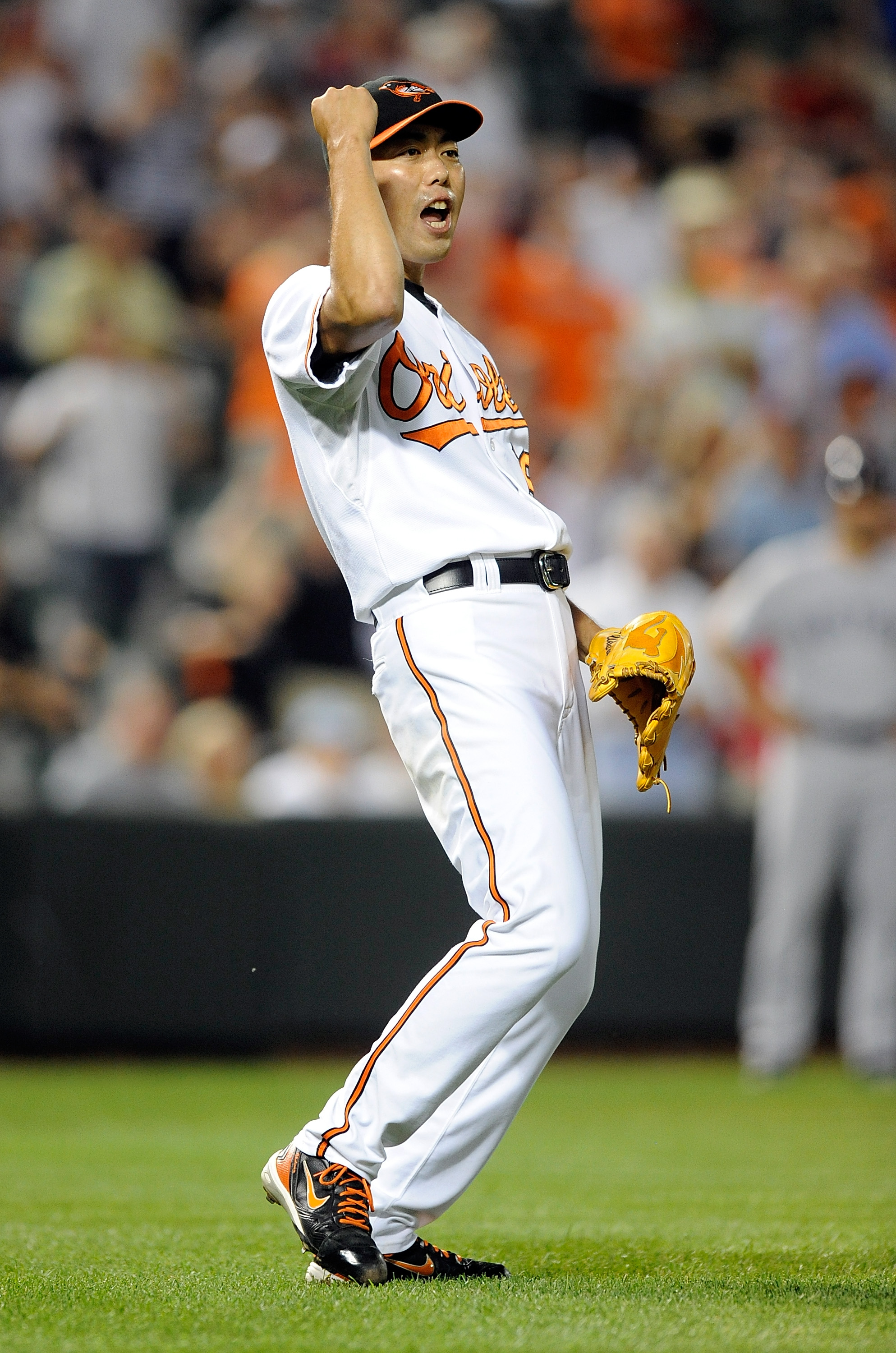 BALTIMORE - AUGUST 31:  Koji Uehara #19 of the Baltimore Orioles celebrates after the final out in a 5-2 victory against the Boston Red Sox at Camden Yards on August 31, 2010 in Baltimore, Maryland.  (Photo by Greg Fiume/Getty Images)