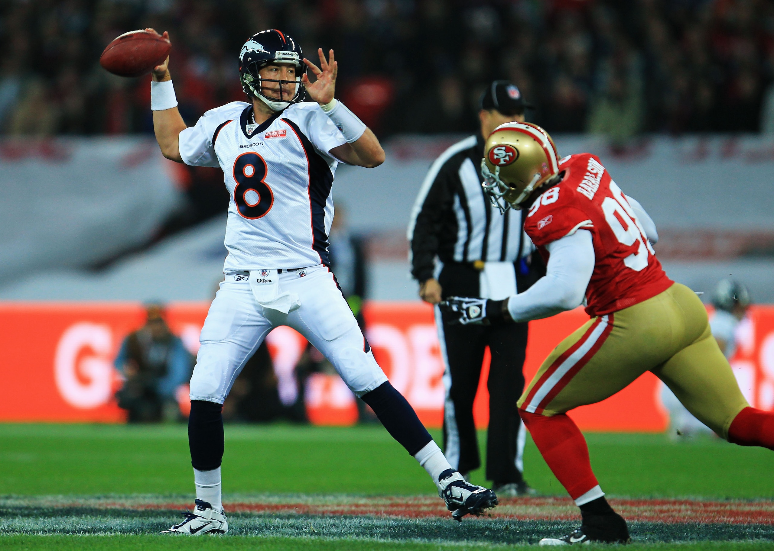 LONDON, ENGLAND - OCTOBER 31:  Kyle Orton #8 of Denver Broncos prepares to release the ball under pressure from Parys Haralston #98 of San Francisco 49ers during the NFL International Series match between Denver Broncos and San Francisco 49ers at Wembley