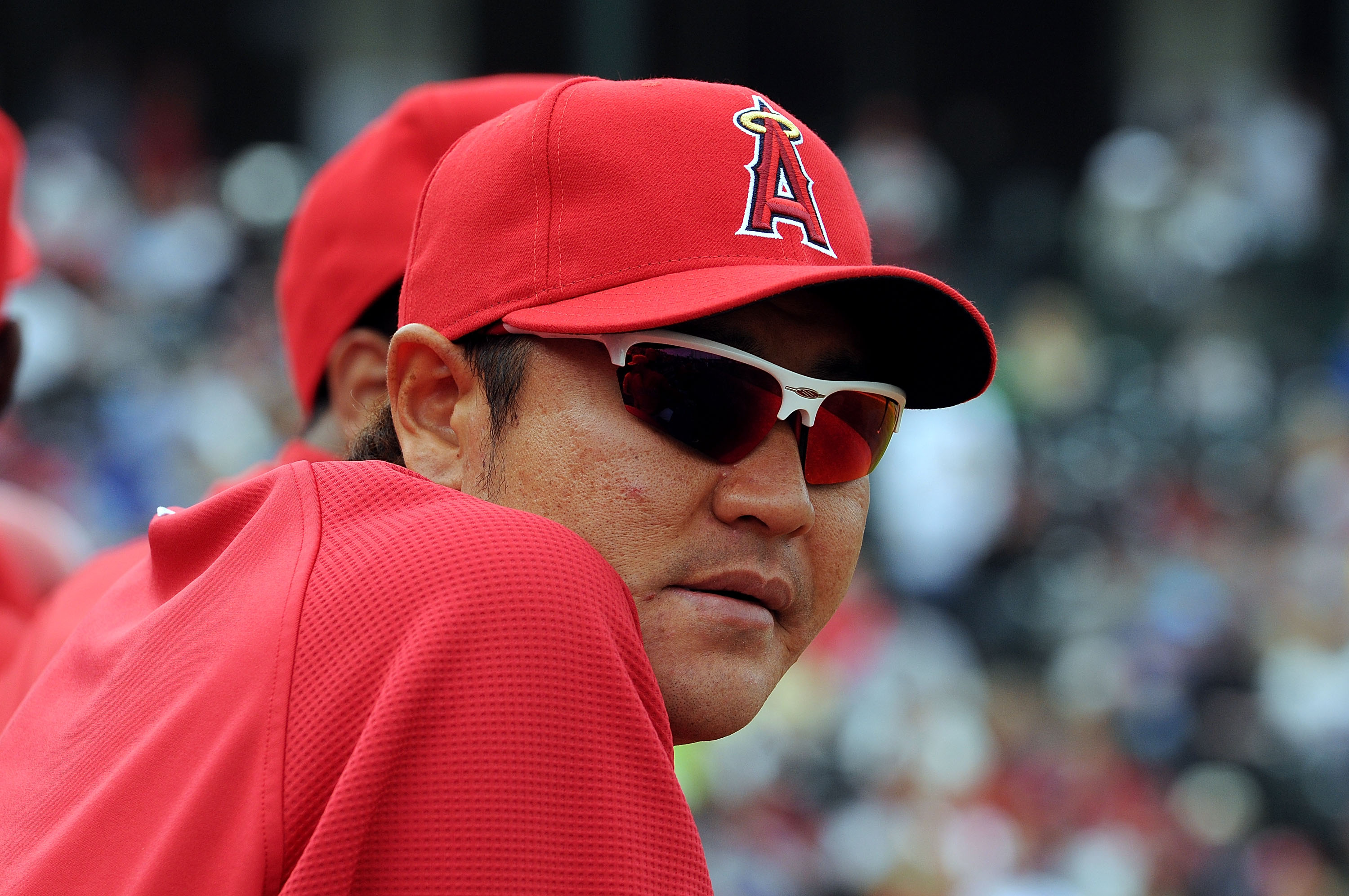 TEMPE, AZ - FEBRUARY 26:  Hisanori Takahashi #21 of the Los Angeles Angels of Anaheim watches from the bench during a game against the Los Angeles Dodgers at Tempe Diablo Stadium on February 26, 2011 in Tempe, Arizona.  (Photo by Norm Hall/Getty Images)