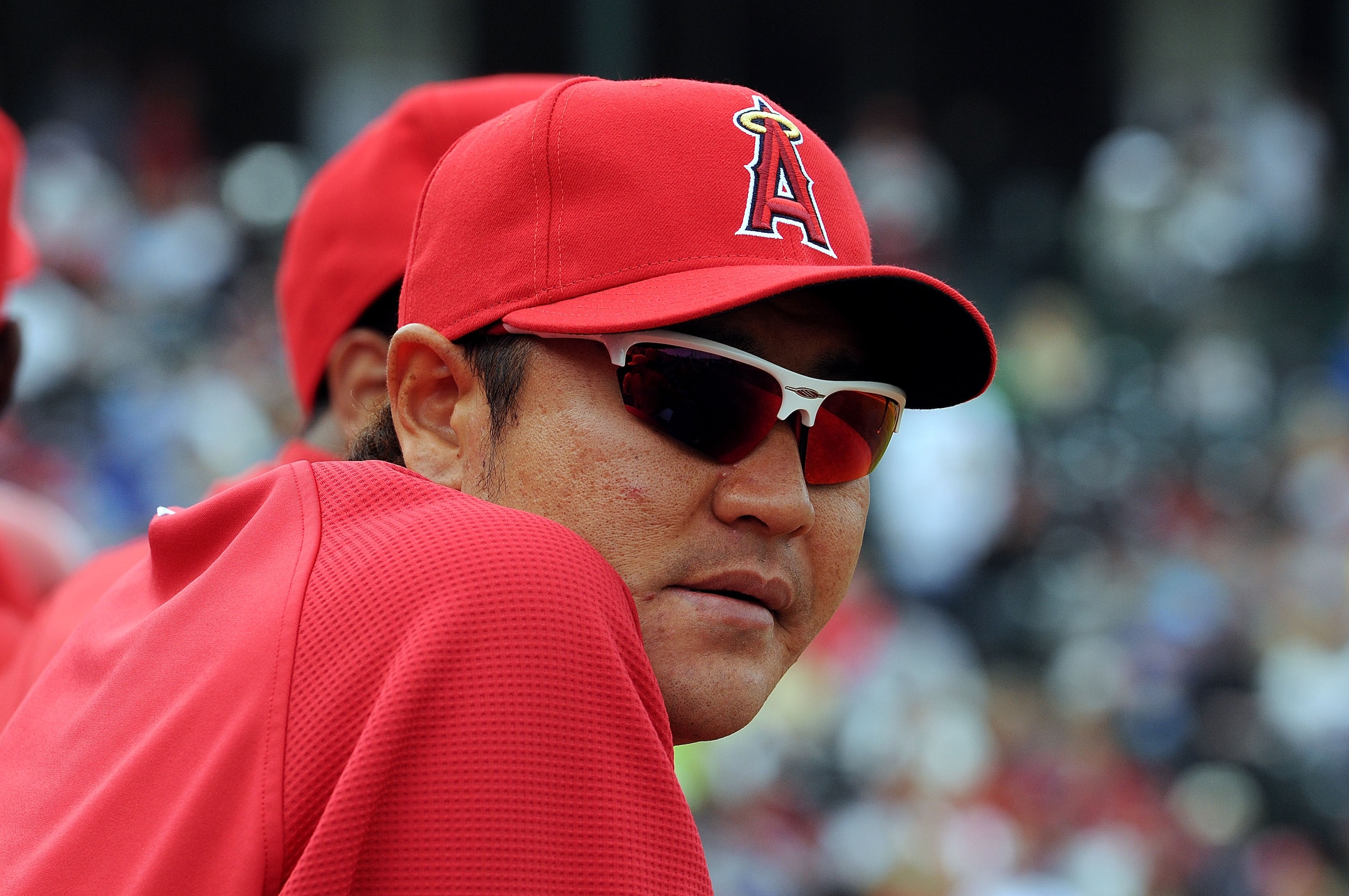 TEMPE, AZ - FEBRUARY 26:  Hisanori Takahashi #21 of the Los Angeles Angels of Anaheim watches from the bench during a game against the Los Angeles Dodgers at Tempe Diablo Stadium on February 26, 2011 in Tempe, Arizona.  (Photo by Norm Hall/Getty Images)