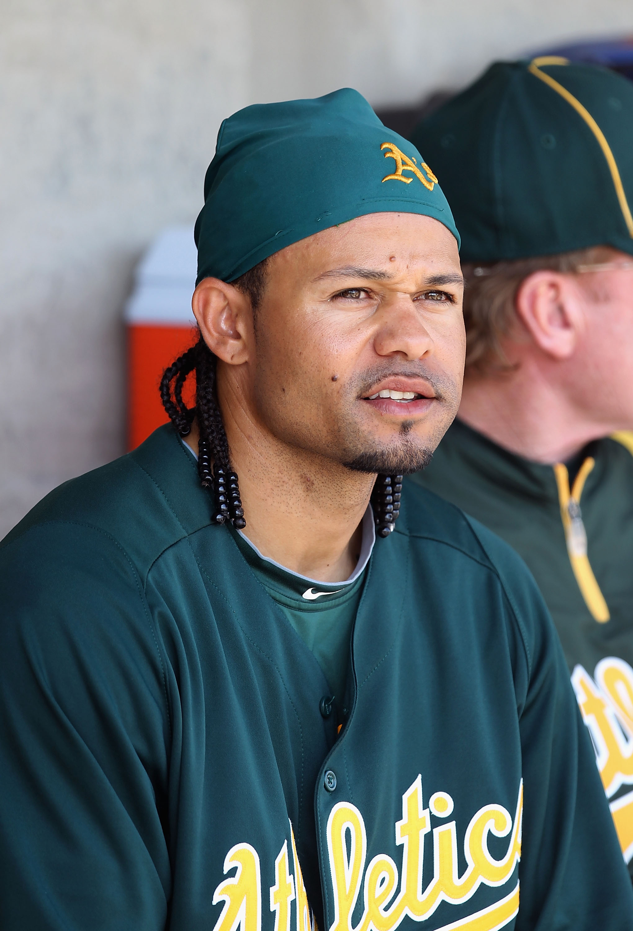 PHOENIX, AZ - MARCH 03:  Coco Crisp #4 of the Oakland Athletics sits in the dugout before the spring training game against the Milwaukee Brewers at Maryvale Baseball Park on March 3, 2011 in Phoenix, Arizona.  (Photo by Christian Petersen/Getty Images)