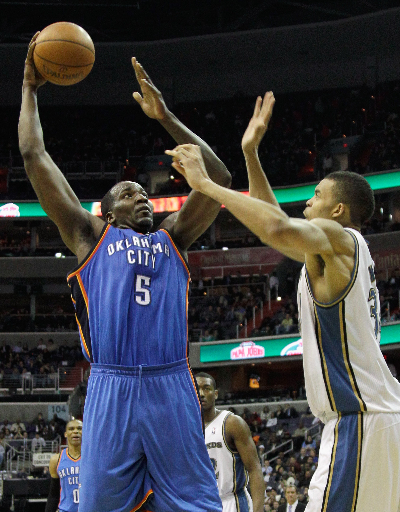 WASHINGTON, DC - MARCH 14: Kendrick Perkins #5 of the Oklahoma City Thunder puts up a shot in front of JaVale McGee #34 of the Washington Wizards during the first half at the Verizon Center on March 14, 2011 in Washington, DC. NOTE TO USER: User expressly