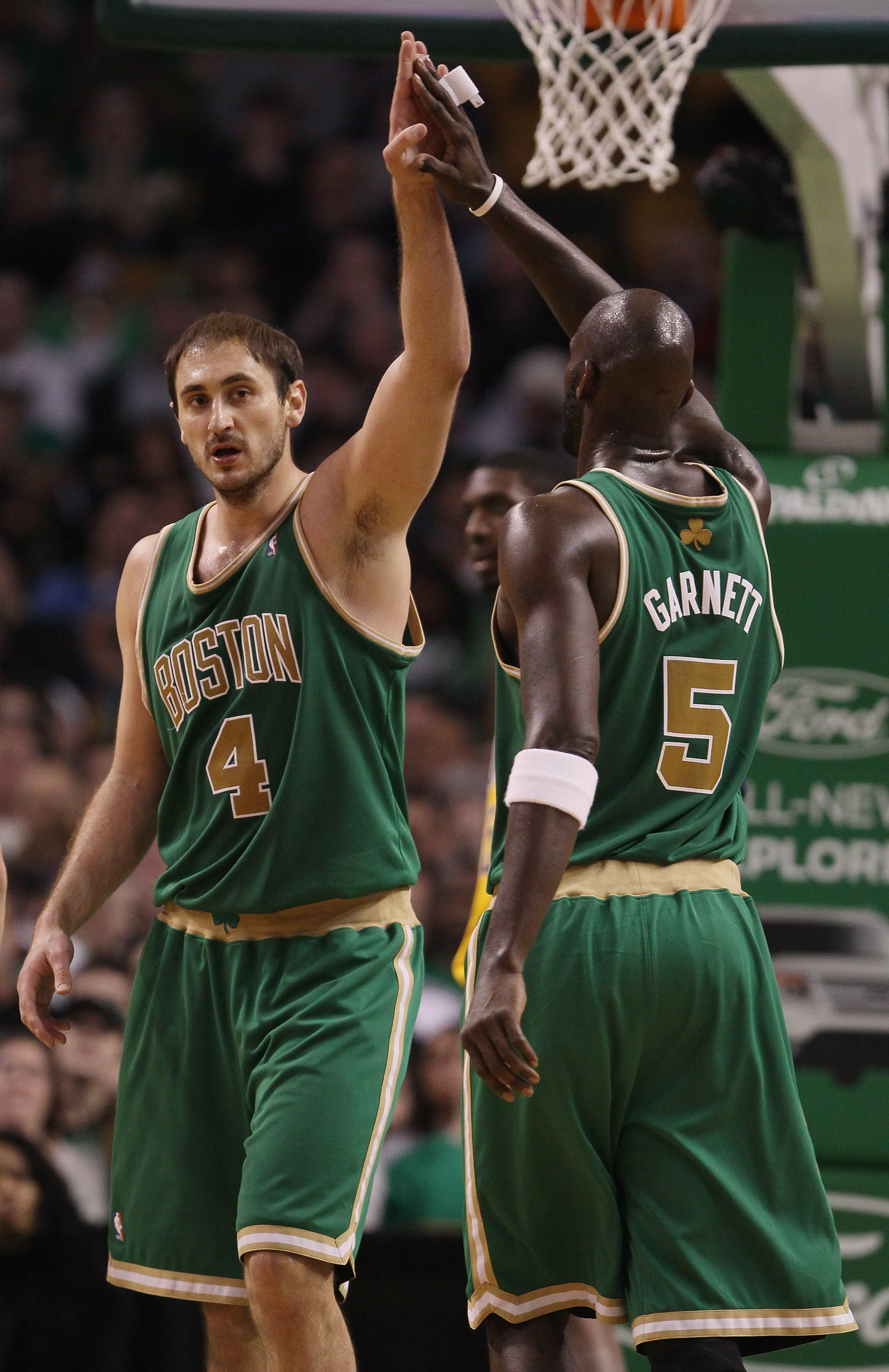 BOSTON, MA - MARCH 16: Nenad Krstic #4 of the Boston Celtics is congratulated by teammate Kevin Garnett #5 after Krstic drew the foul in the second half against the Indiana Pacers on March 16, 2011 at the TD Garden in Boston, Massachusetts. The Celtics d