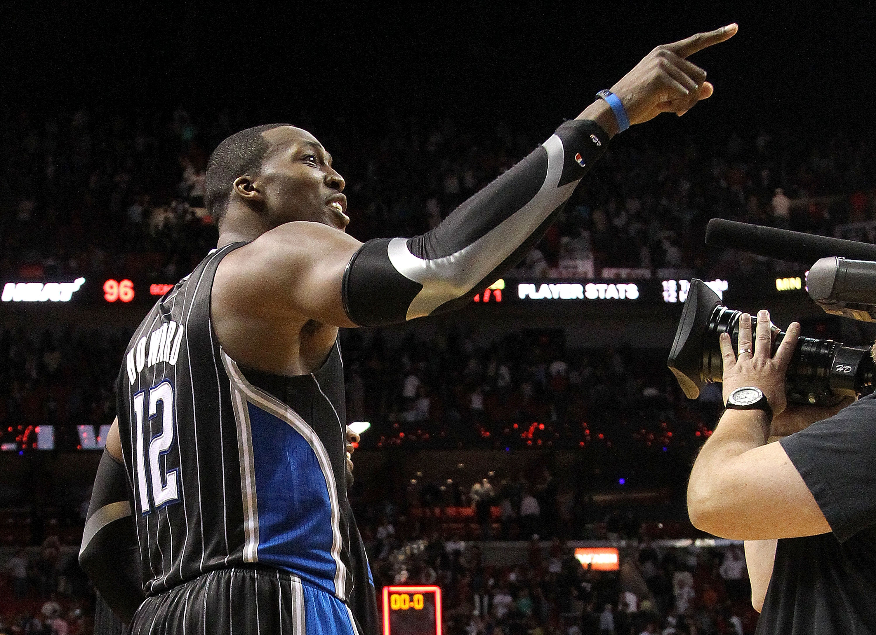 MIAMI, FL - MARCH 03:  Dwight Howard #12 of the Orlando Magic points to a heckler after winning a game against the Miami Heat at American Airlines Arena on March 3, 2011 in Miami, Florida. NOTE TO USER: User expressly acknowledges and agrees that, by down