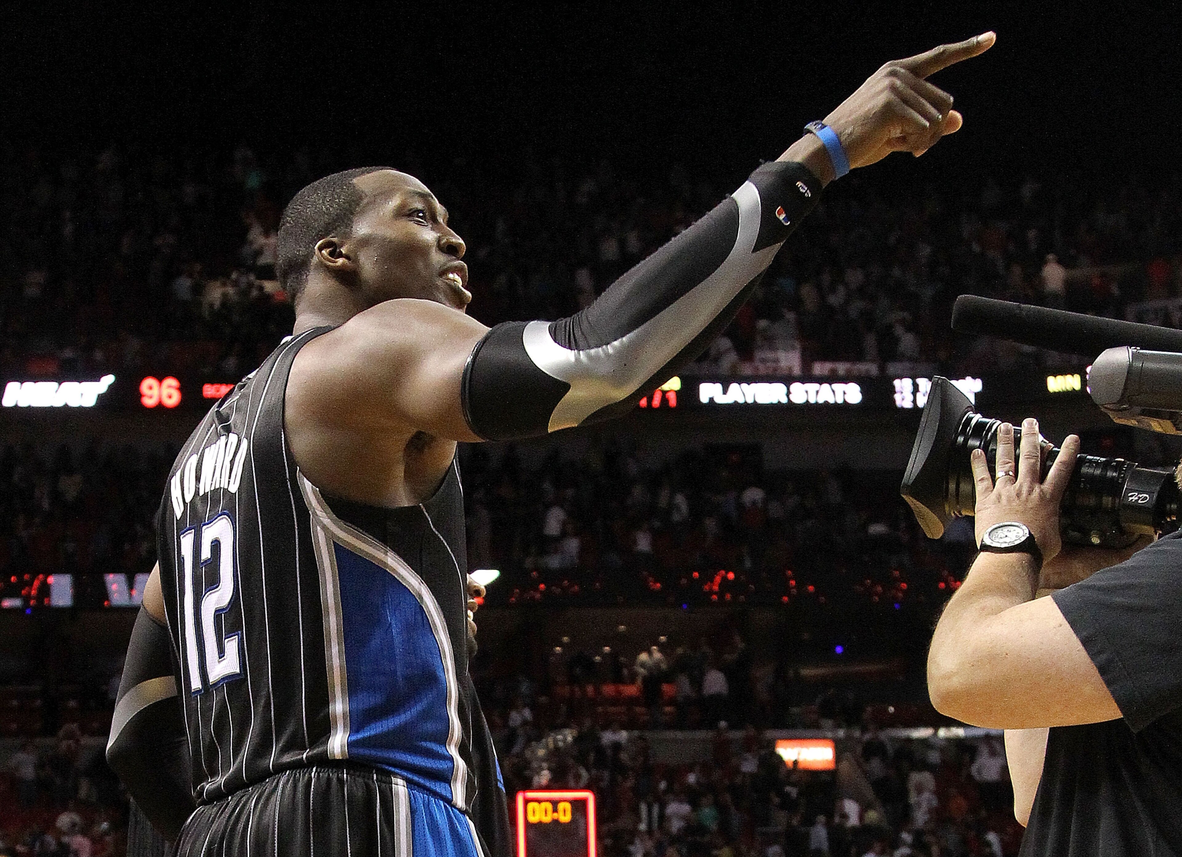 MIAMI, FL - MARCH 03: Dwight Howard #12 of the Orlando Magic points to a heckler after winning a game against the Miami Heat at American Airlines Arena on March 3, 2011 in Miami, Florida. NOTE TO USER: User expressly acknowledges and agrees that, by down MIAMI, FL - MARCH 03: Dwight Howard #12 of the Orlando Magic points to a heckler after winning a game against the Miami Heat at American Airlines Arena on March 3, 2011 in Miami, Florida. NOTE TO USER: User expressly acknowledges and agrees that, by down