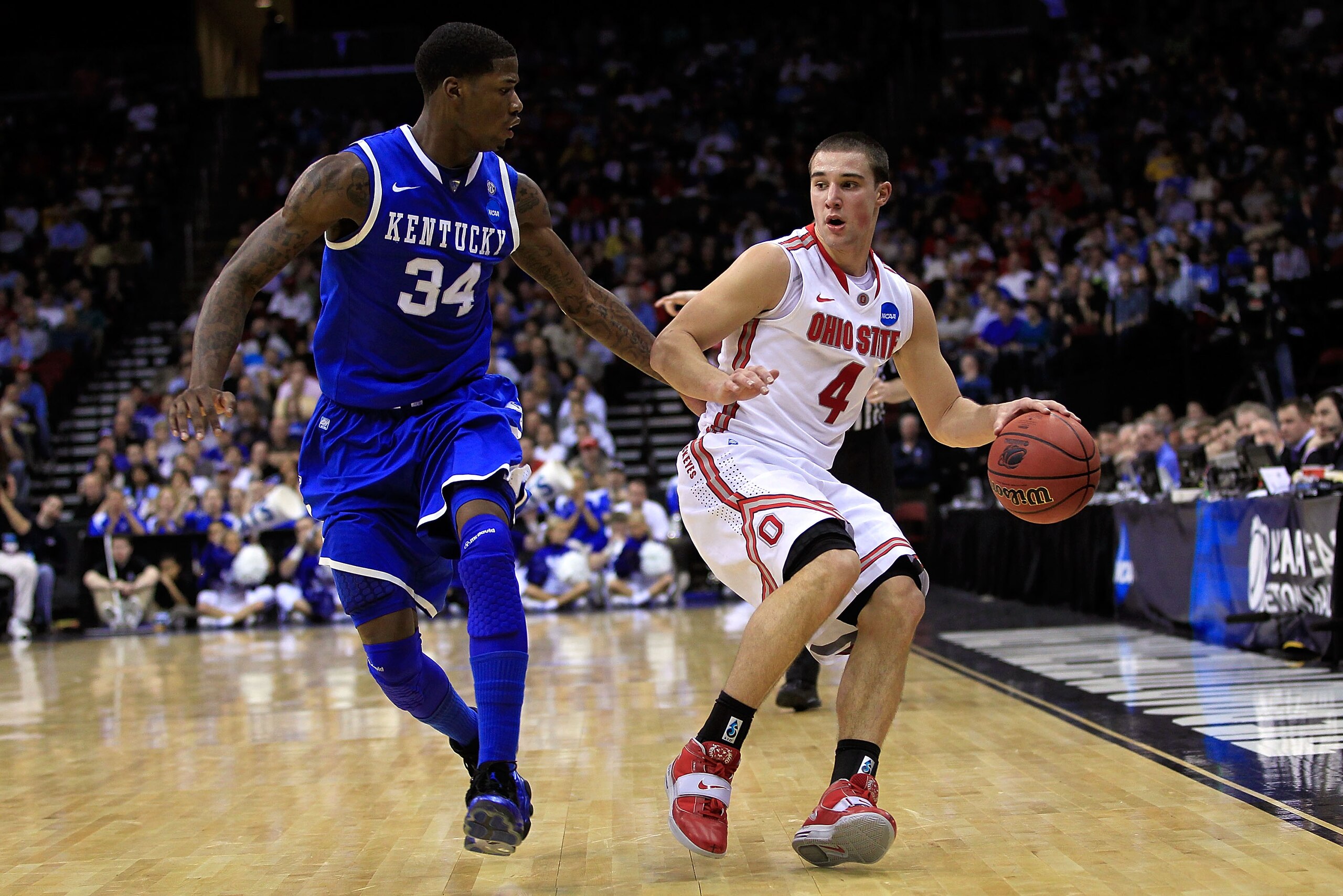 NEWARK, NJ - MARCH 25:  Aaron Craft #4 of the Ohio State Buckeyes brings the ball up court against DeAndre Liggins #34 of the Kentucky Wildcats during the east regional semifinal of the 2011 NCAA Men's Basketball Tournament at the Prudential Center on Mar