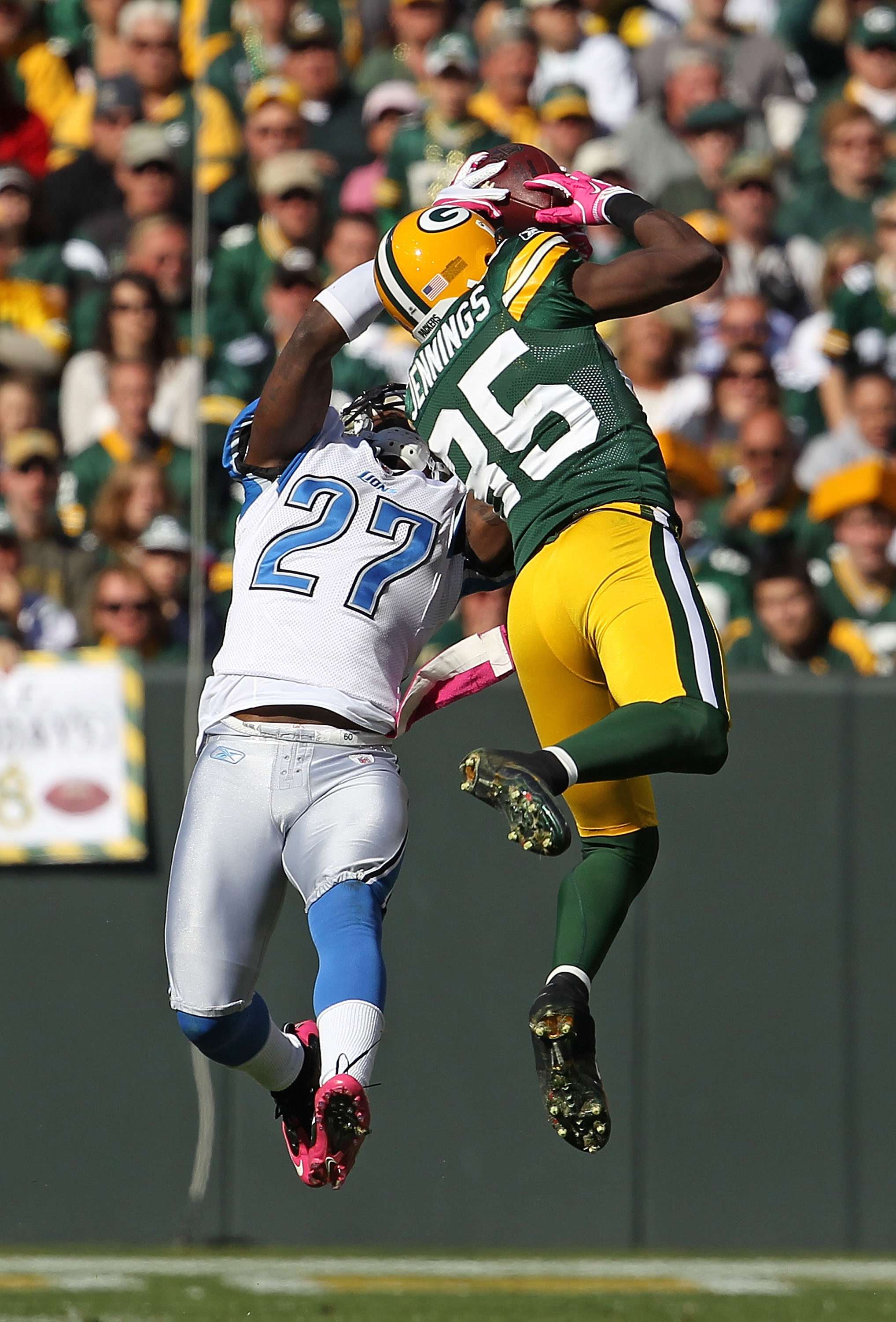 GREEN BAY, WI - OCTOBER 03: Alphonso Smith #27 of the Detroit Lions takes the ball away from Greg Jennings #85 of the Green Bay Packers for an interception at Lambeau Field on October 3, 2010 in Green Bay, Wisconsin. The Packers defeated the Lions 28-26.