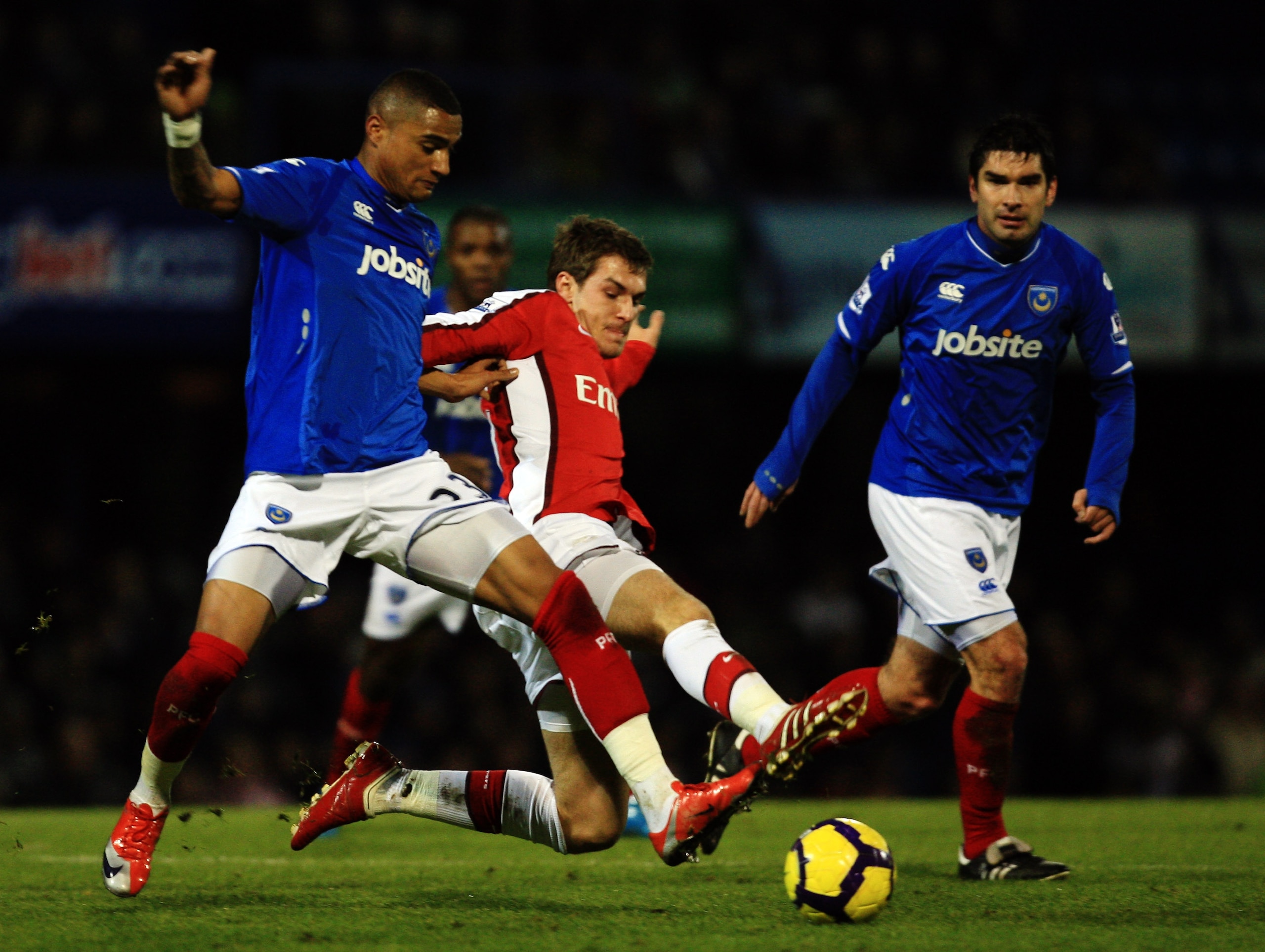 PORTSMOUTH, ENGLAND - DECEMBER 30:  Kevin-Prince Boateng of Portsmouth challenges Aaron Ramsey vof Arsenal during the Barclays Premier League match between Portsmouth and Arsenal at Fratton Park on December 30, 2009 in Portsmouth, England.  (Photo by Bryn