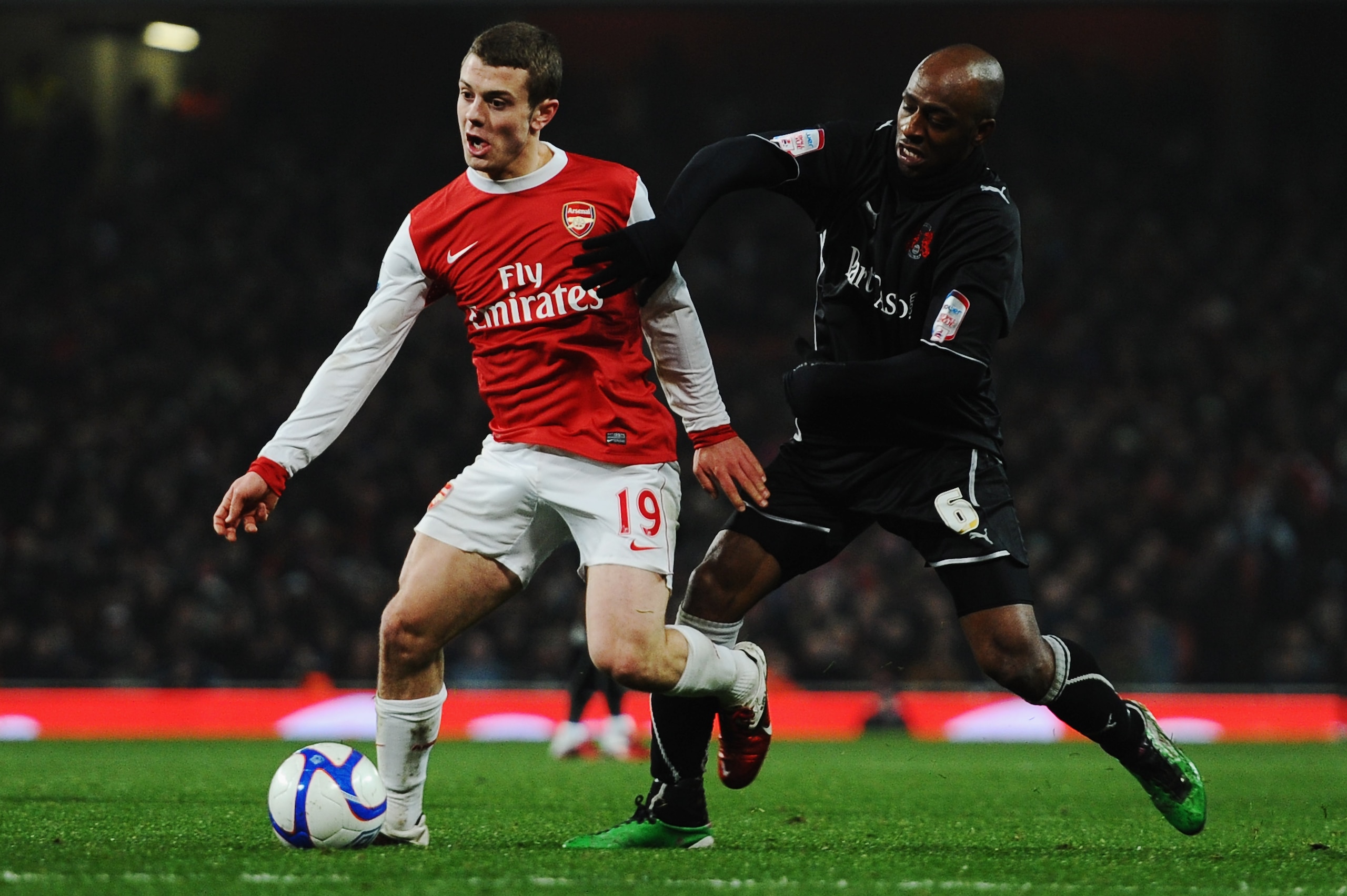LONDON, UNITED KINGDOM - MARCH 02:  Jack Wilshere (L) of Arsenal holds off the challenge of Terrell Forbes (R) of Leyton Orient during the FA Cup sponsored by E.ON 5th Round Replay match between between Arsenal and Leyton Orient at the Emirates Stadium on