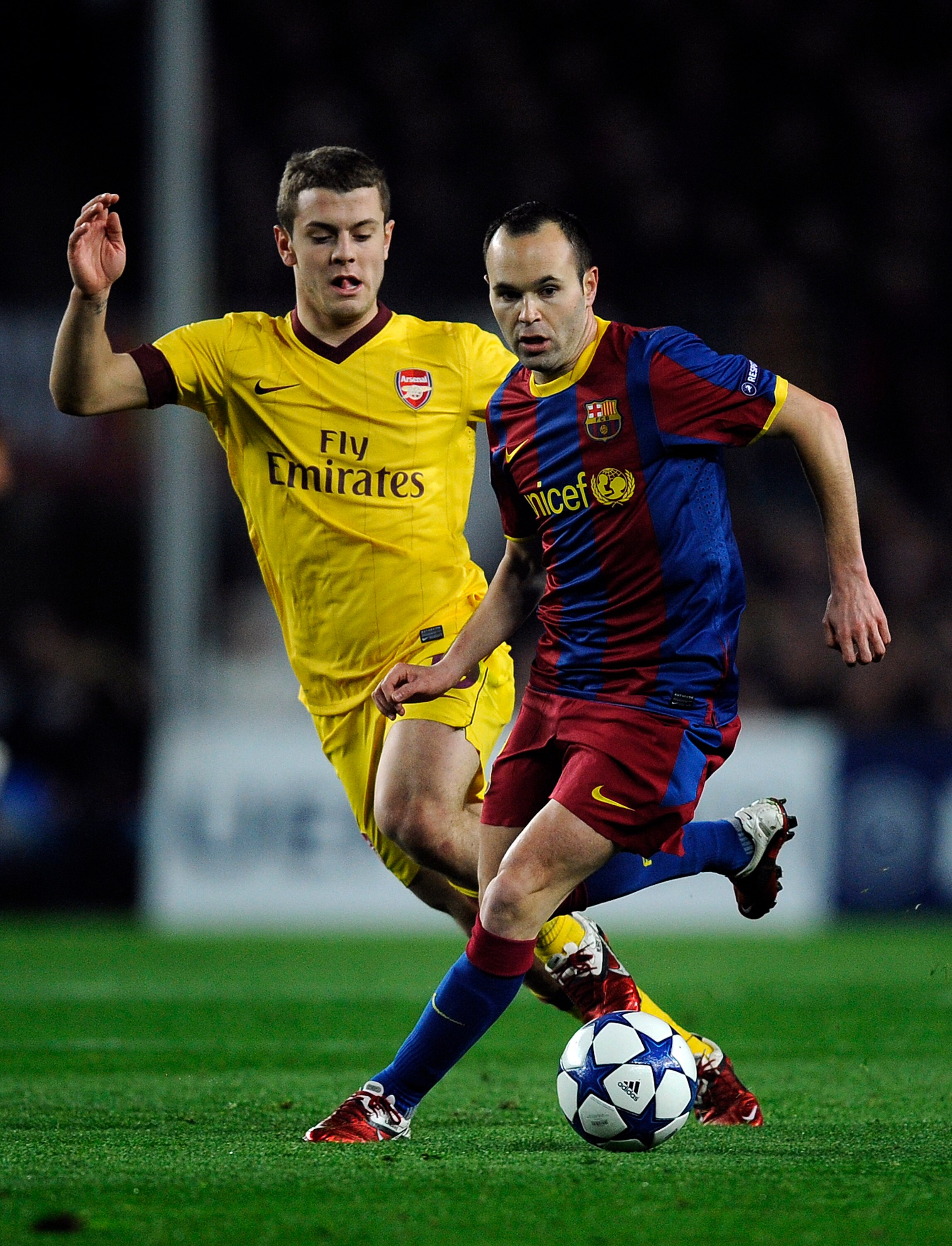 BARCELONA, SPAIN - MARCH 08:  Andres Inieta of FC Barcelona (R) duels for the ball against Jack Wilshere of Arsenal during the UEFA Champions League round of 16 second leg match between Barcelona and Arsenal at the Camp Nou stadium on March 8, 2011 in Bar