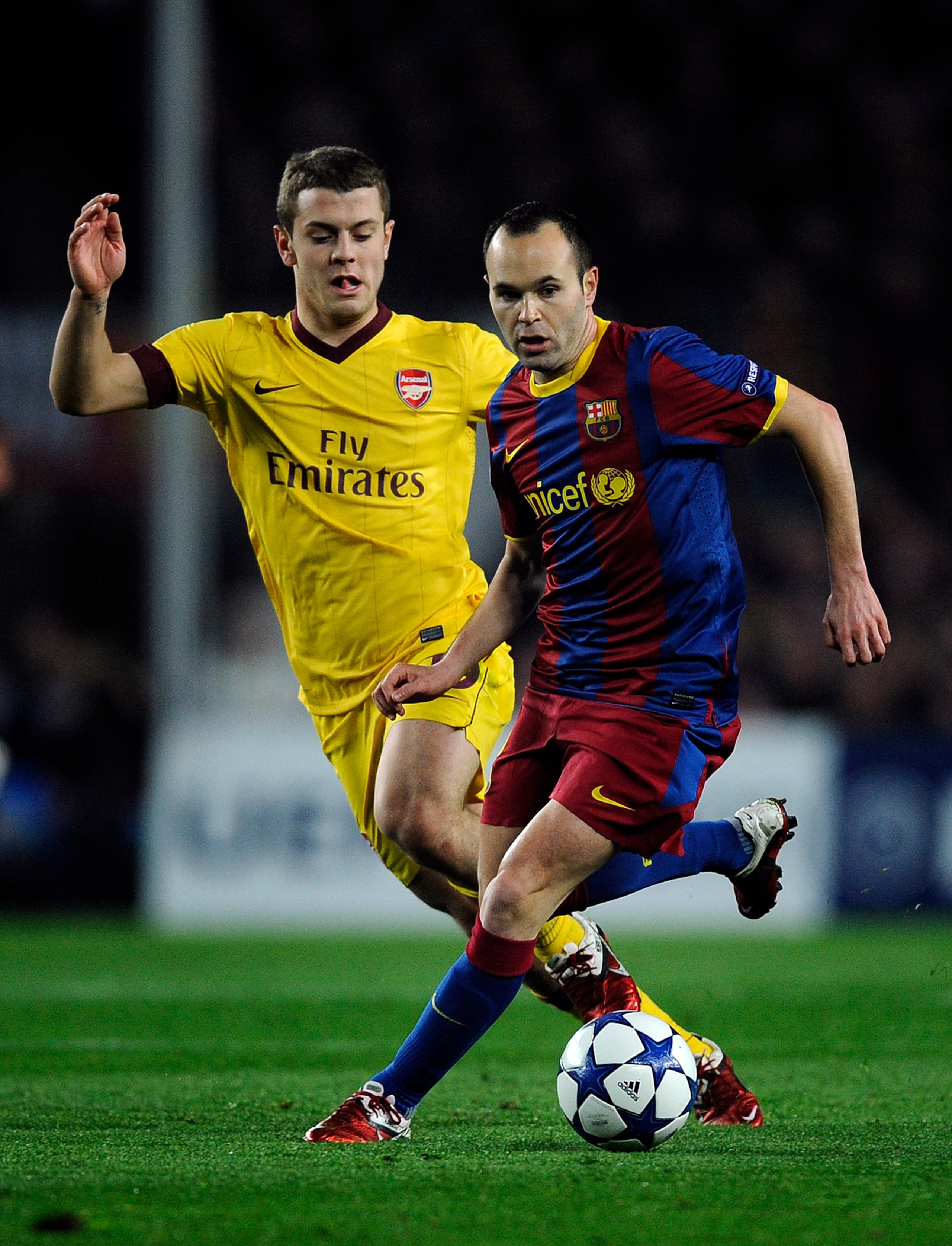 BARCELONA, SPAIN - MARCH 08:  Andres Inieta of FC Barcelona (R) duels for the ball against Jack Wilshere of Arsenal during the UEFA Champions League round of 16 second leg match between Barcelona and Arsenal at the Camp Nou stadium on March 8, 2011 in Bar
