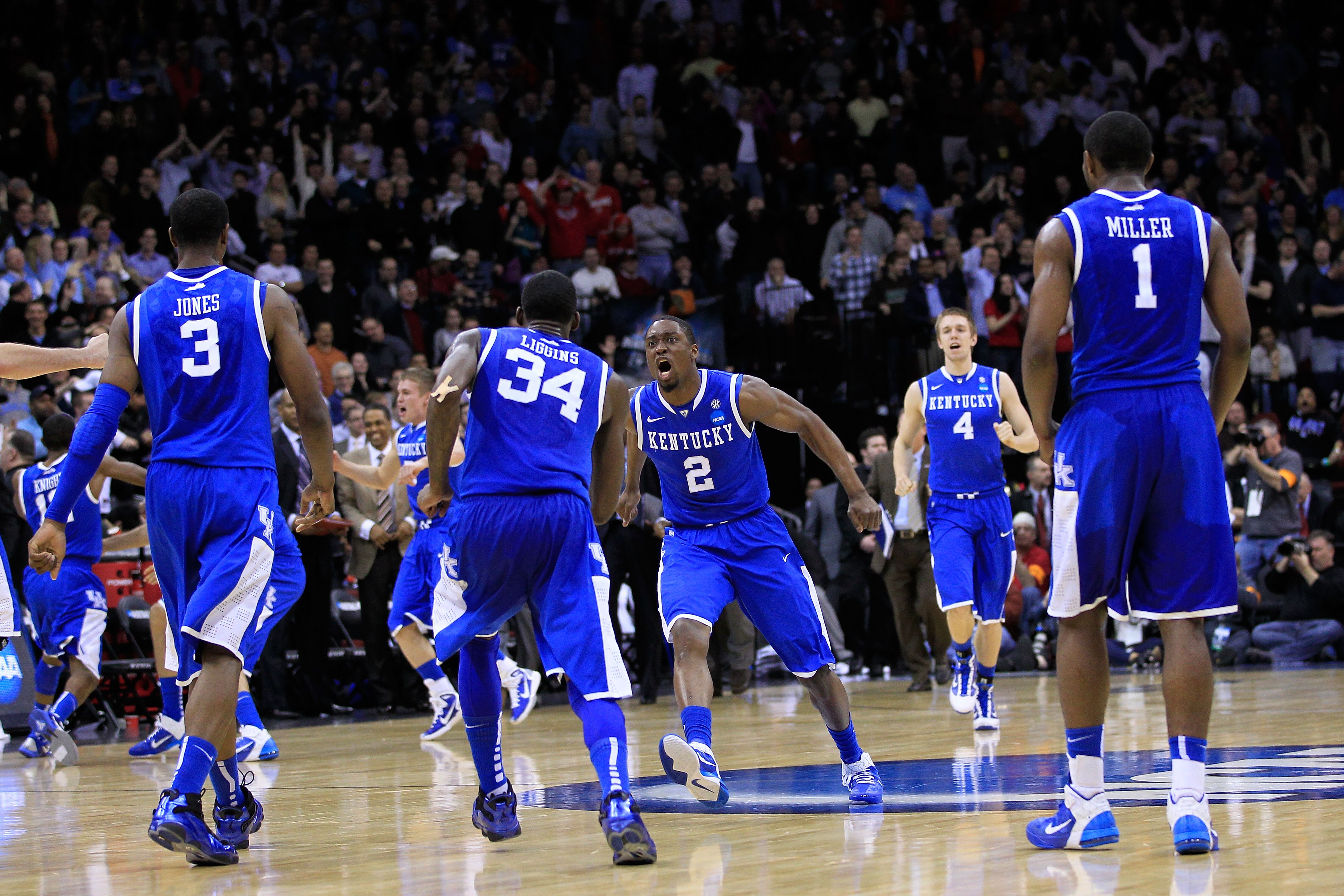 NEWARK, NJ - MARCH 25:  DeAndre Liggins #34 of the Kentucky Wildcats celebrates with teammate Stacey Poole Jr. #2 after defeating the Ohio State Buckeyes in the east regional semifinal of the 2011 NCAA Men's Basketball Tournament at the Prudential Center