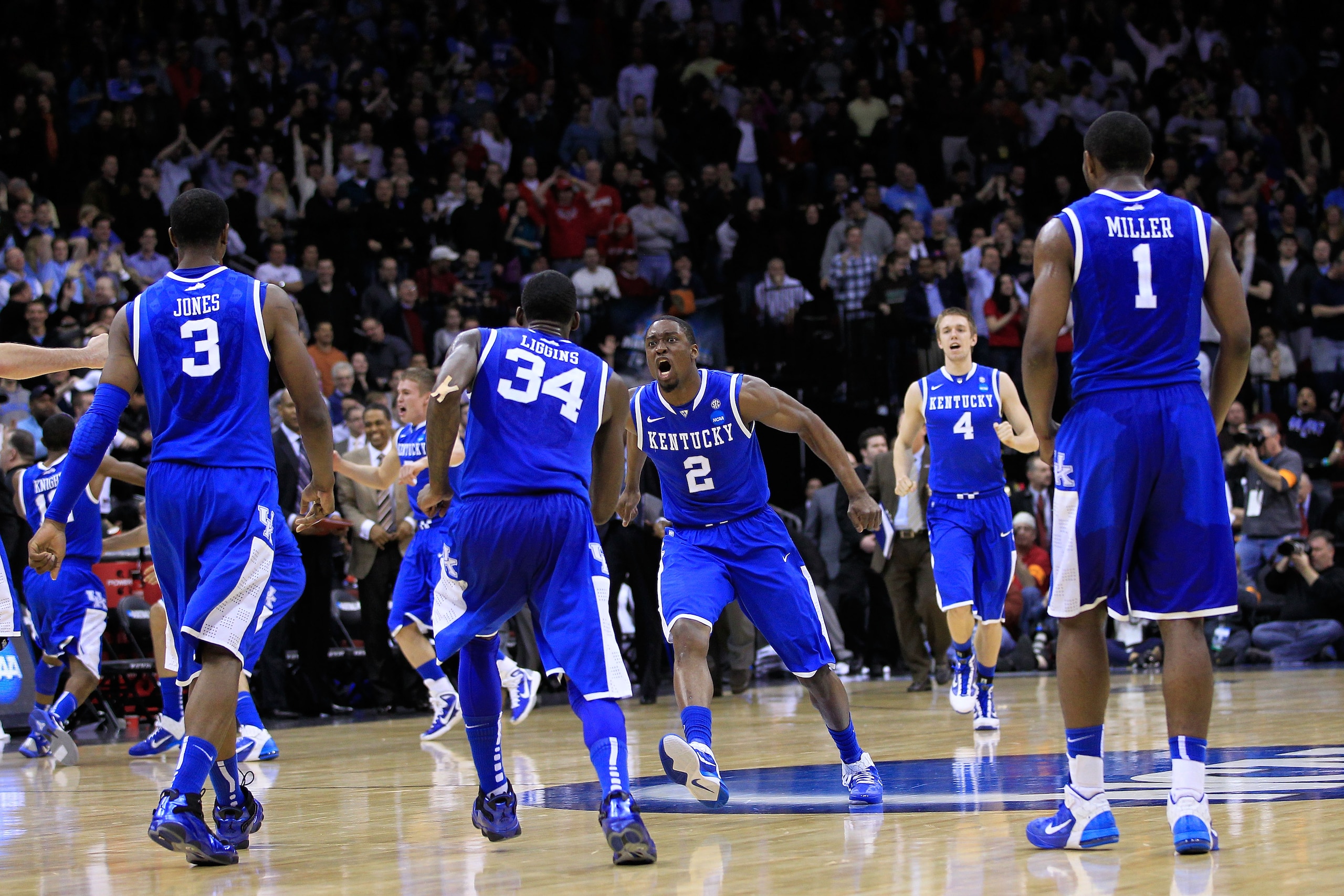 NEWARK, NJ - MARCH 25:  DeAndre Liggins #34 of the Kentucky Wildcats celebrates with teammate Stacey Poole Jr. #2 after defeating the Ohio State Buckeyes in the east regional semifinal of the 2011 NCAA Men's Basketball Tournament at the Prudential Center