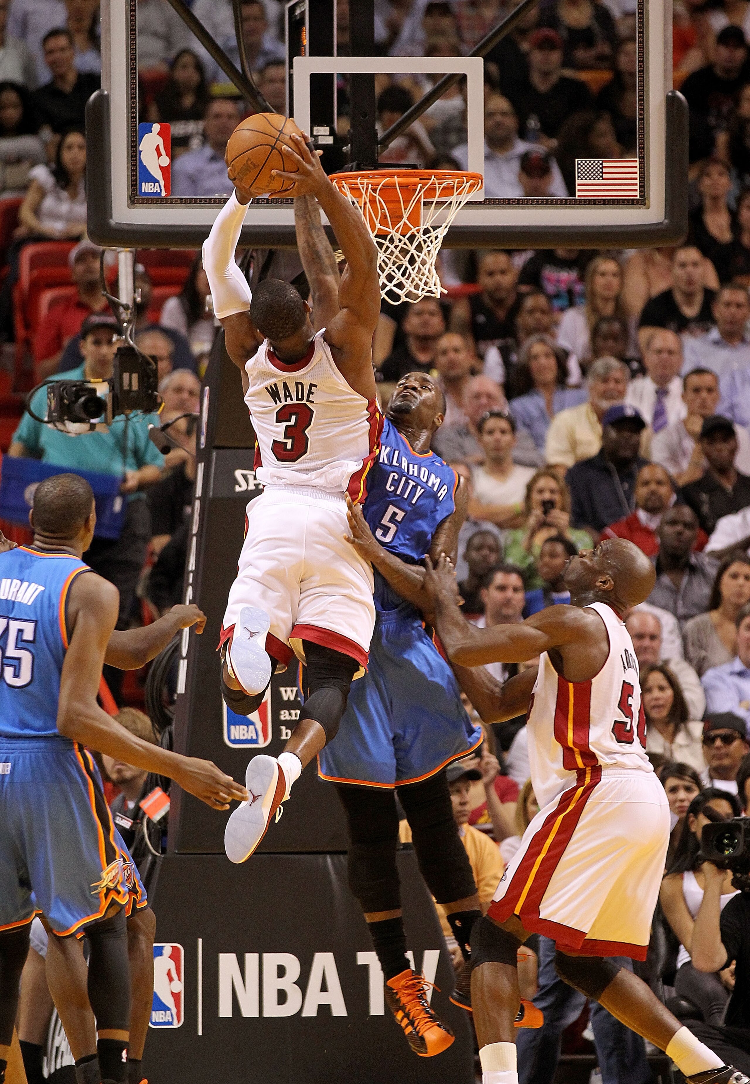 MIAMI, FL - MARCH 16: Dwyane Wade #3 of the Miami Heat dunks over Kendrick Perkins #5 of the Oklahoma City Thunder during a game at American Airlines Arena on March 16, 2011 in Miami, Florida. NOTE TO USER: User expressly acknowledges and agrees that, by MIAMI, FL - MARCH 16: Dwyane Wade #3 of the Miami Heat dunks over Kendrick Perkins #5 of the Oklahoma City Thunder during a game at American Airlines Arena on March 16, 2011 in Miami, Florida. NOTE TO USER: User expressly acknowledges and agrees that, by