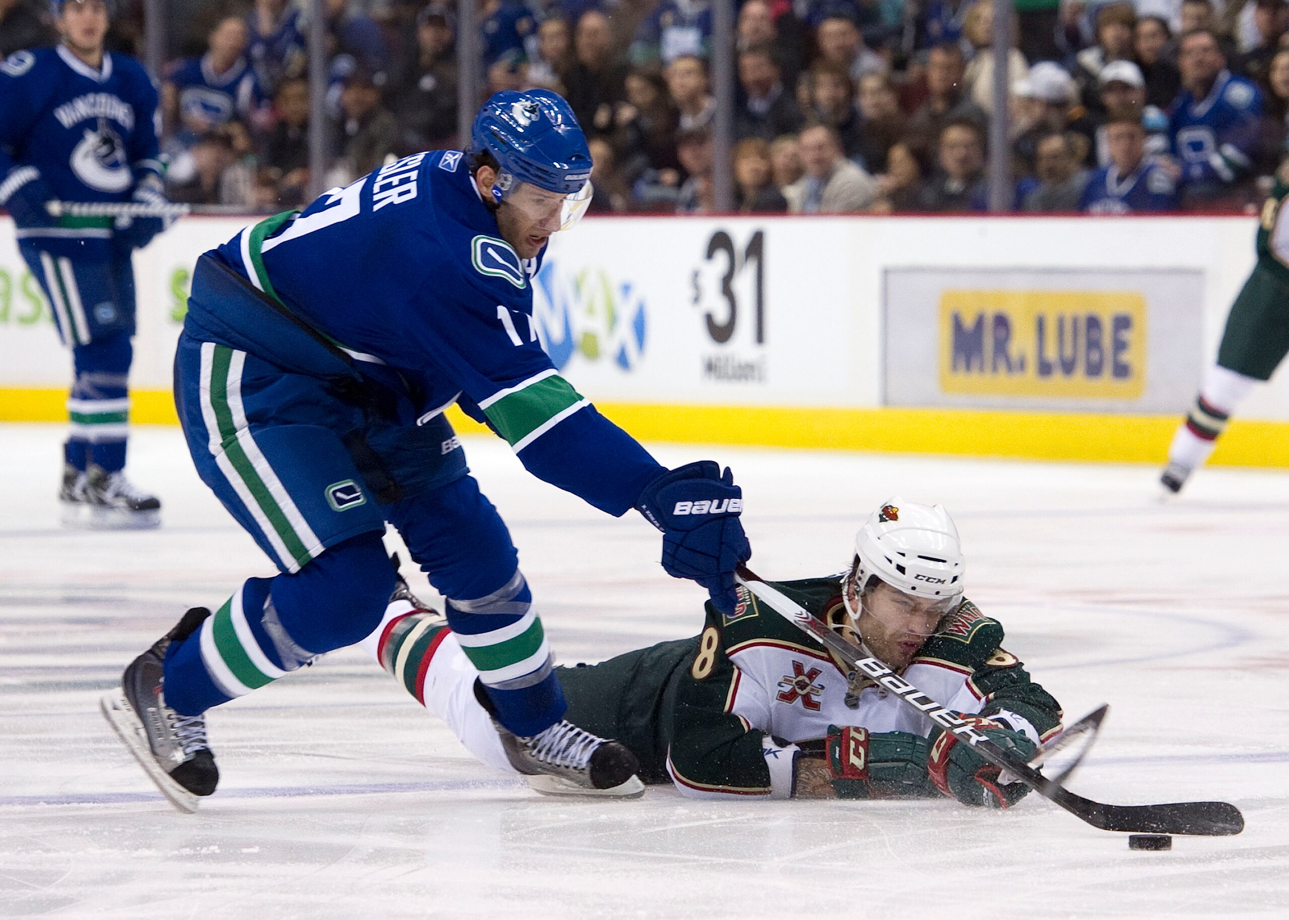 VANCOUVER, CANADA - MARCH 14: Brent Burns #8 of the Minnesota Wild dives to knock the puck away from Ryan Kesler #17 of the Vancouver Canucks during the second period in NHL action on March 14, 2011 at Rogers Arena in Vancouver, British Columbia, Canada.