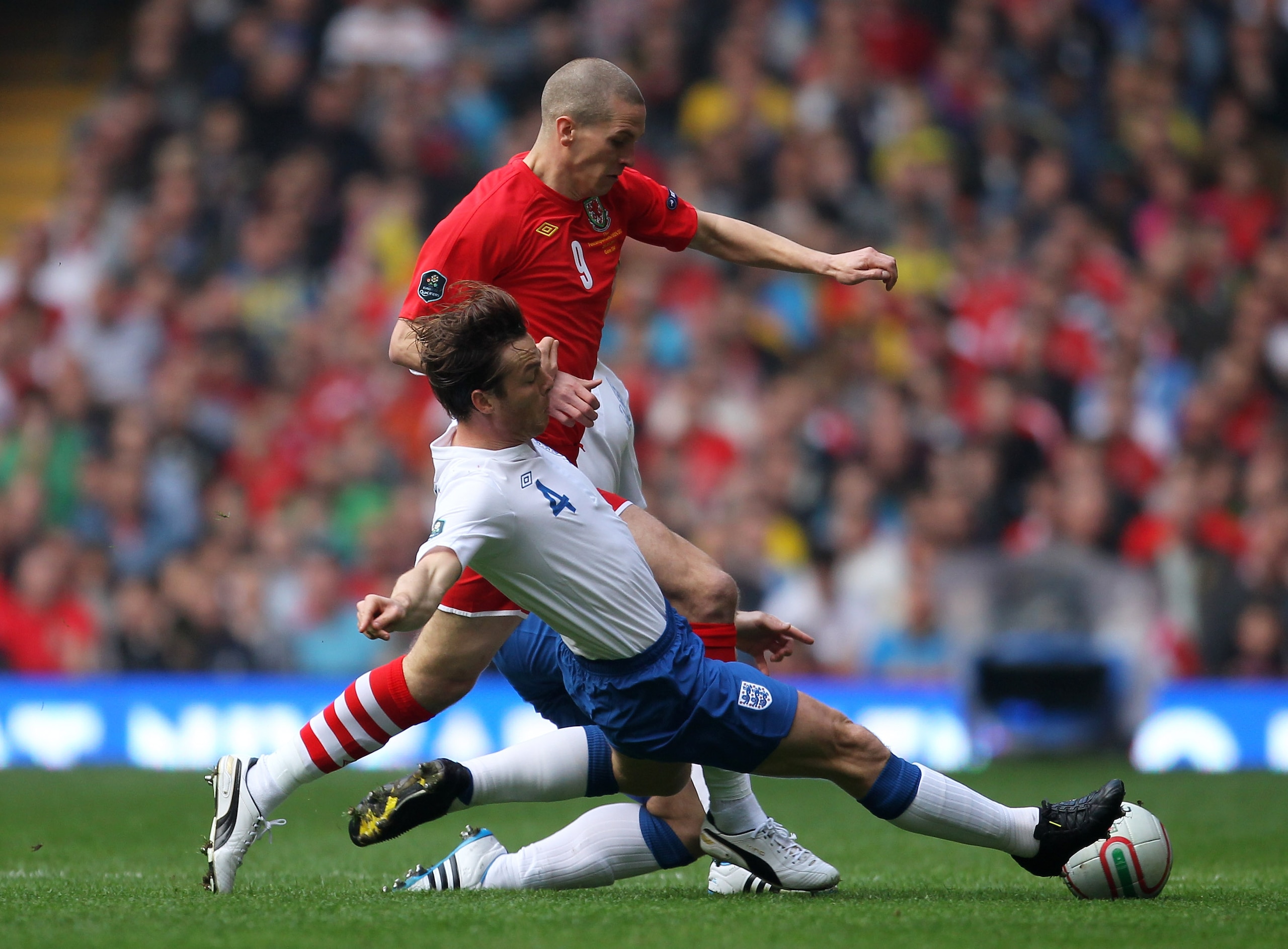 CARDIFF, WALES - MARCH 26: Scott Parker of England challenges Steve Morison of Wales during the UEFA EURO 2012 Group G qualifying match between Wales and England at the Millennium Stadium on March 26, 2011 in Cardiff, Wales.  (Photo by Alex Livesey/Getty