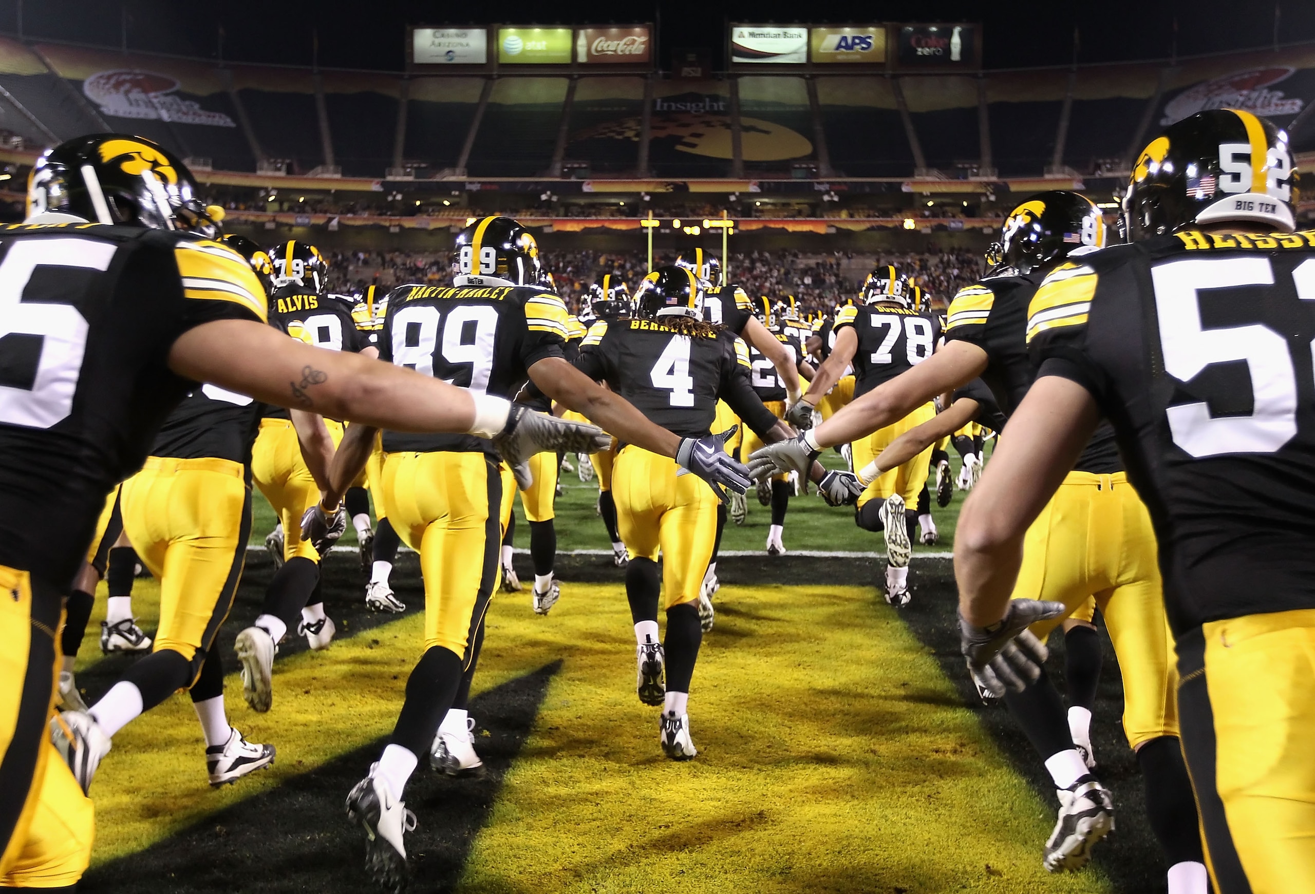 TEMPE, AZ - DECEMBER 28:  The Iowa Hawkeyes run out onto the field before the Insight Bowl against the Missouri Tigers at Sun Devil Stadium on December 28, 2010 in Tempe, Arizona.  The Hawkeyes defeated the Tigers 27-24.  (Photo by Christian Petersen/Gett