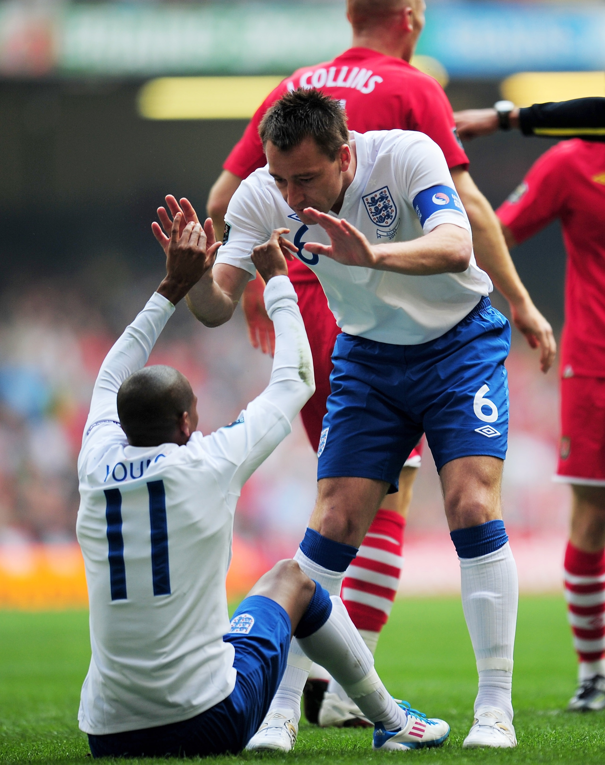 CARDIFF, WALES - MARCH 26:  Ashley Young #11 of England is congratulated by England captain John Terry after winning the penalty for the opening goal during the UEFA EURO 2012 Group G qualifying match between Wales and England at the Millennium Stadium on