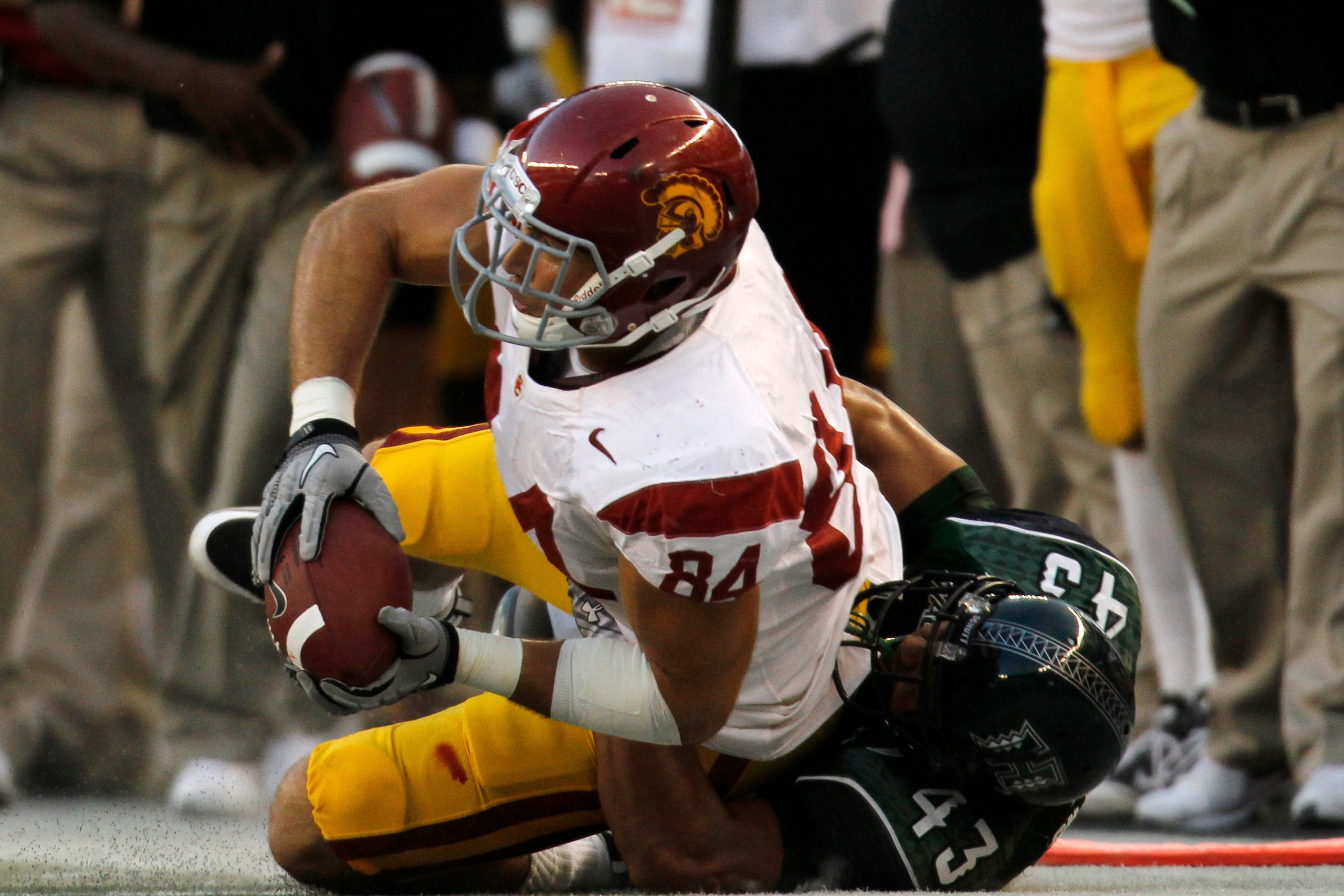 HONOLULU - SEPTEMBER 02: Jordan Cameron #84 of the University of Southern Carolina Trojans is taken down by Mana Silva #43 of the University of Hawaii Warriors during first half action at Aloha Stadium September 2, 2010 in Honolulu, Hawaii. (Photo by Kent