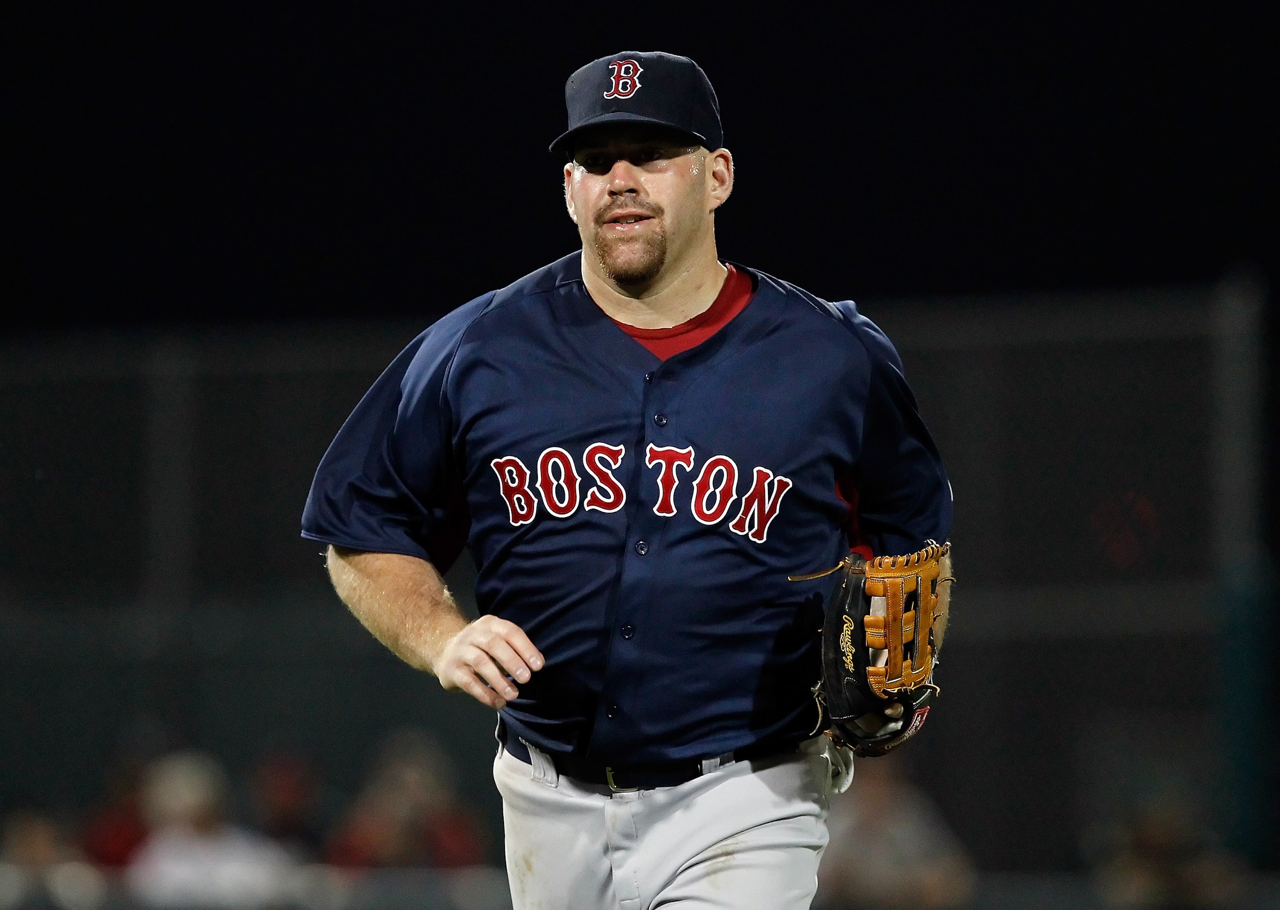 FORT MYERS, FL - FEBRUARY 27:  Infielder Kevin Youkilis #20 of the Boston Red Sox jogs back to the dugout at the end of an inning during a game against the Minnesota Twins during a Grapefruit League Spring Training Game at Hammond Stadium on February 27,