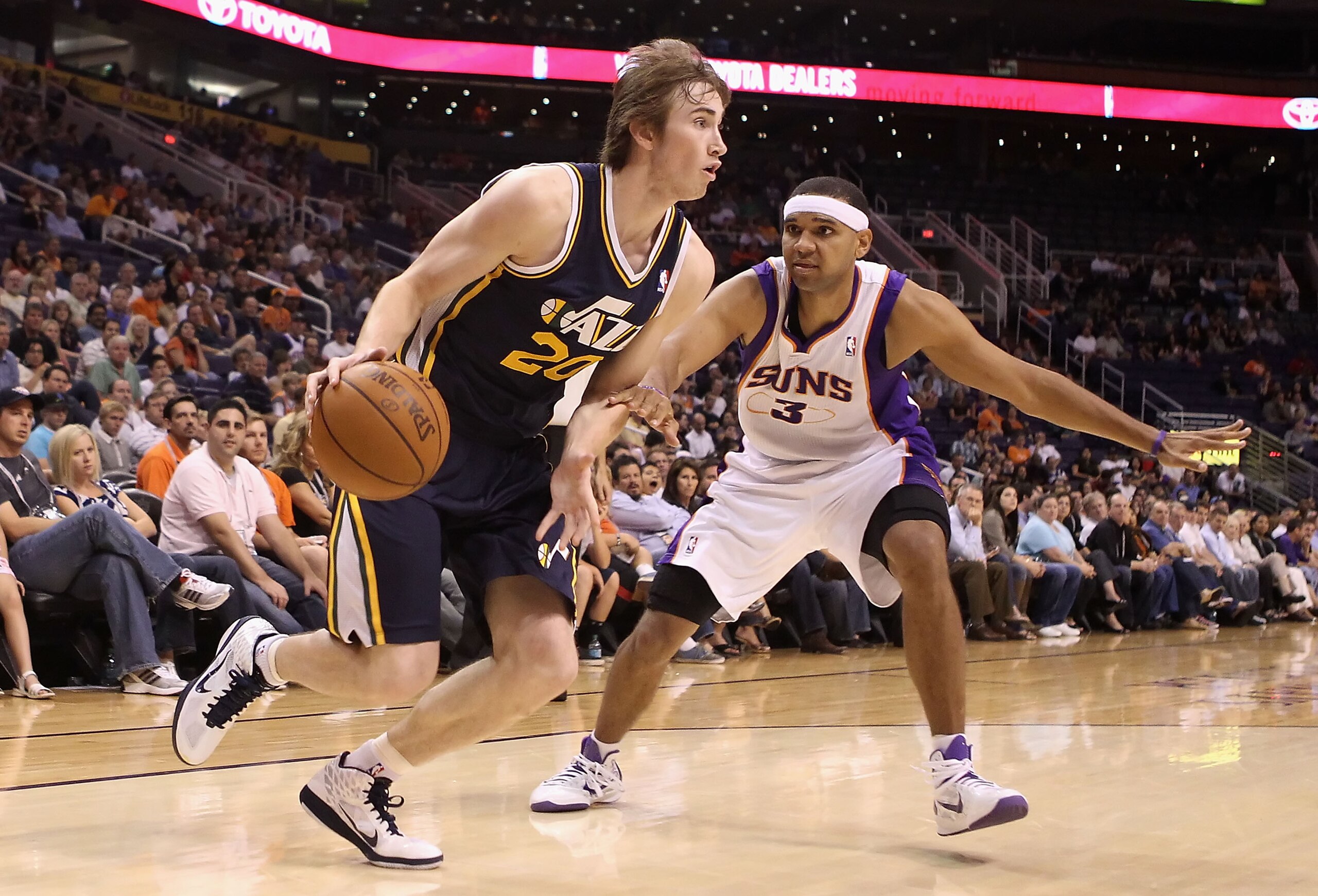 PHOENIX - OCTOBER 12:  Gordon Hayward #20 of the Utah Jazz drives the ball past Jared Dudley #3 of the Phoenix Suns during the preseason NBA game at US Airways Center on October 12, 2010 in Phoenix, Arizona. NOTE TO USER: User expressly acknowledges and a