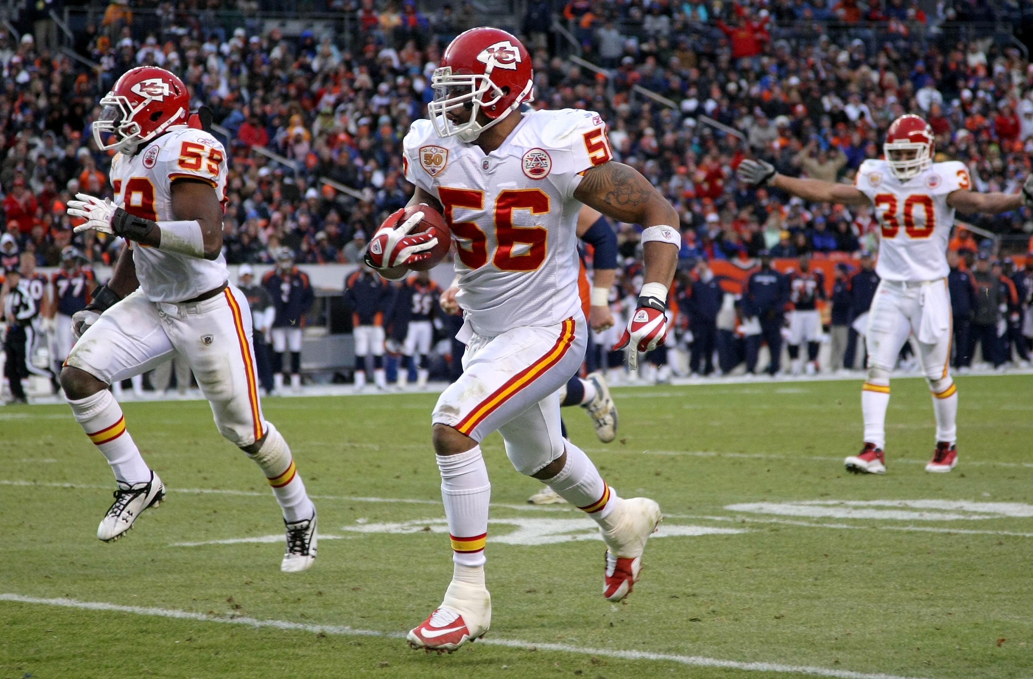 DENVER - JANUARY 03:  Linebacker Derrick Johnson #56 of the Kansas City Chiefs intercepts a pass by Kyle Orton of the Denver Broncos and returns it 45 yards for a touchdown to give the Chiefs a 27-17 lead in the third quarter during NFL action at Invesco