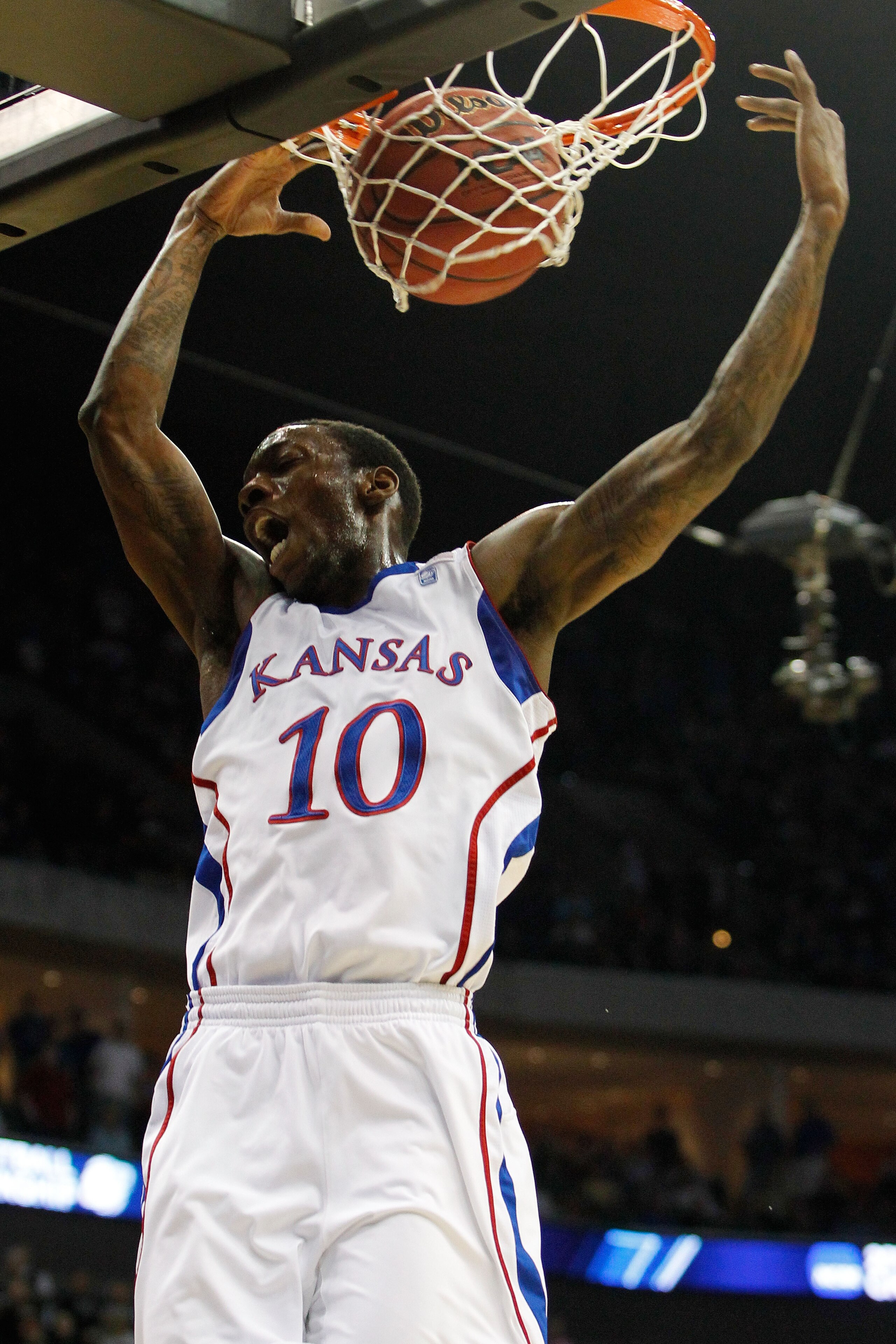 TULSA, OK - MARCH 20:  Tyshawn Taylor #10 of the Kansas Jayhawks dunks the ball against the Illinois Fighting Illini during the third round of the 2011 NCAA men's basketball tournament at BOK Center on March 20, 2011 in Tulsa, Oklahoma.  (Photo by Tom Pen