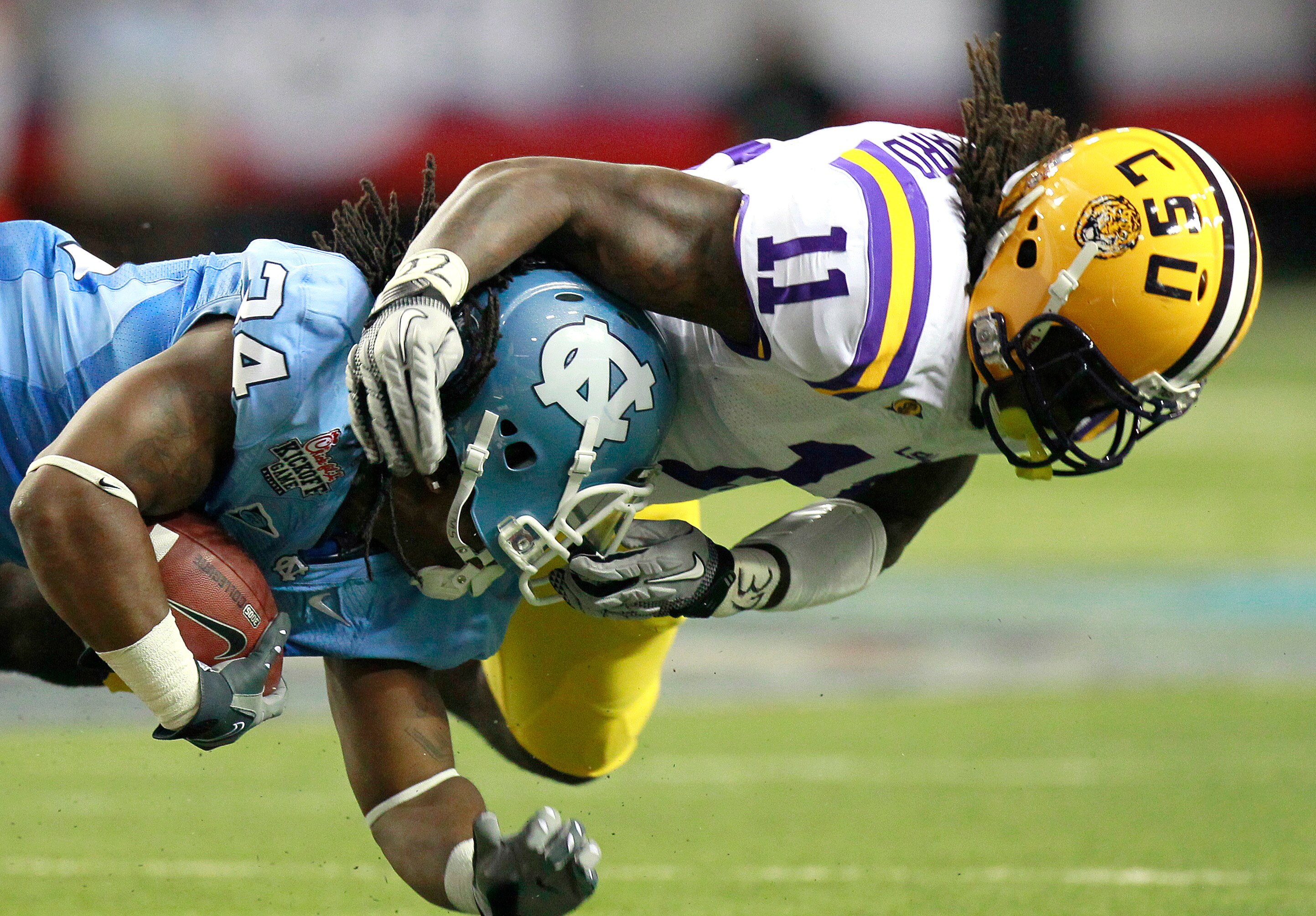 ATLANTA - SEPTEMBER 4: Kelvin Sheppard #11 of the LSU Tigers tackles Johnny White #34 of the North Carolina Tar Heels at the Georgia Dome September 4, 2010 in Atlanta, Georgia.  (Photo by Kevin C. Cox/Getty Images)