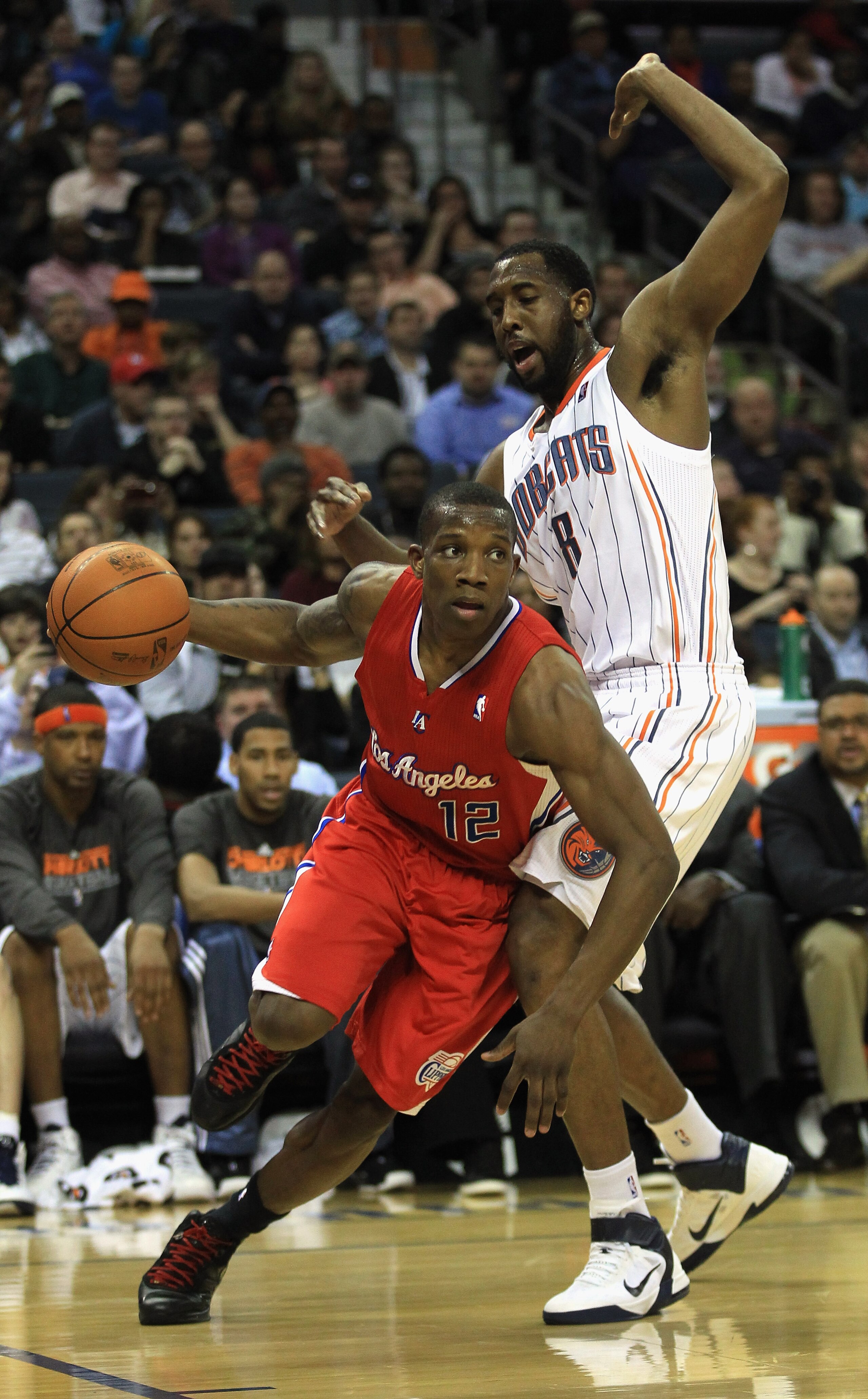 CHARLOTTE, NC - MARCH 07:  Eric Bledsoe #12 of the Los Angeles Clippers drives past DJ White #8 of the Charlotte Bobcats during their game at Time Warner Cable Arena on March 7, 2011 in Charlotte, North Carolina. NOTE TO USER: User expressly acknowledges