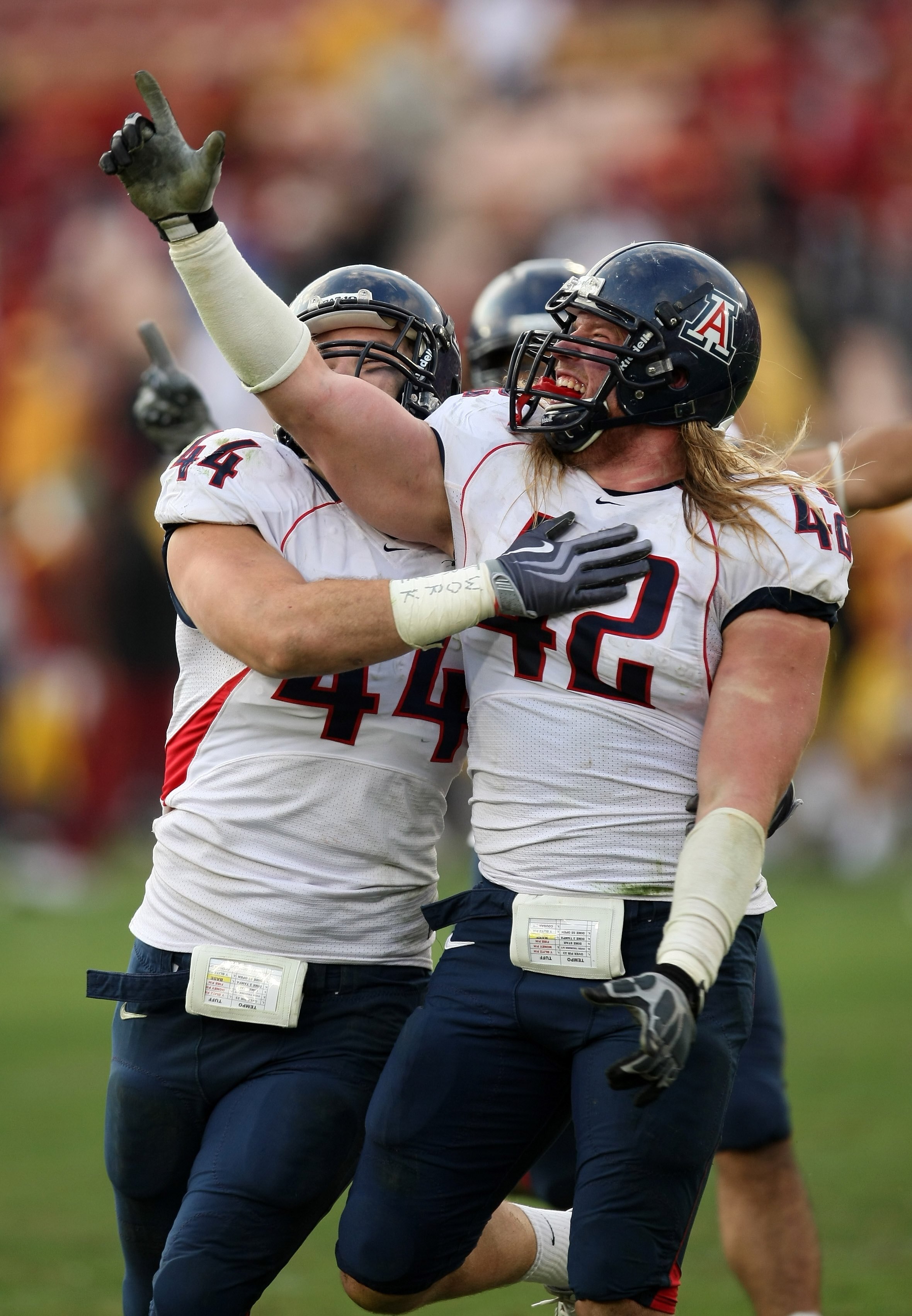 LOS ANGELES, CA - DECEMBER 05:  Defensive ends Brooks Reed #42 and Ricky Elmore #44 of the Arizona Wildcats celebrate after stopping the USC Trojans on the final play on December 5, 2009 at the Los Angeles Coliseum in Los Angeles, California. Arizona won