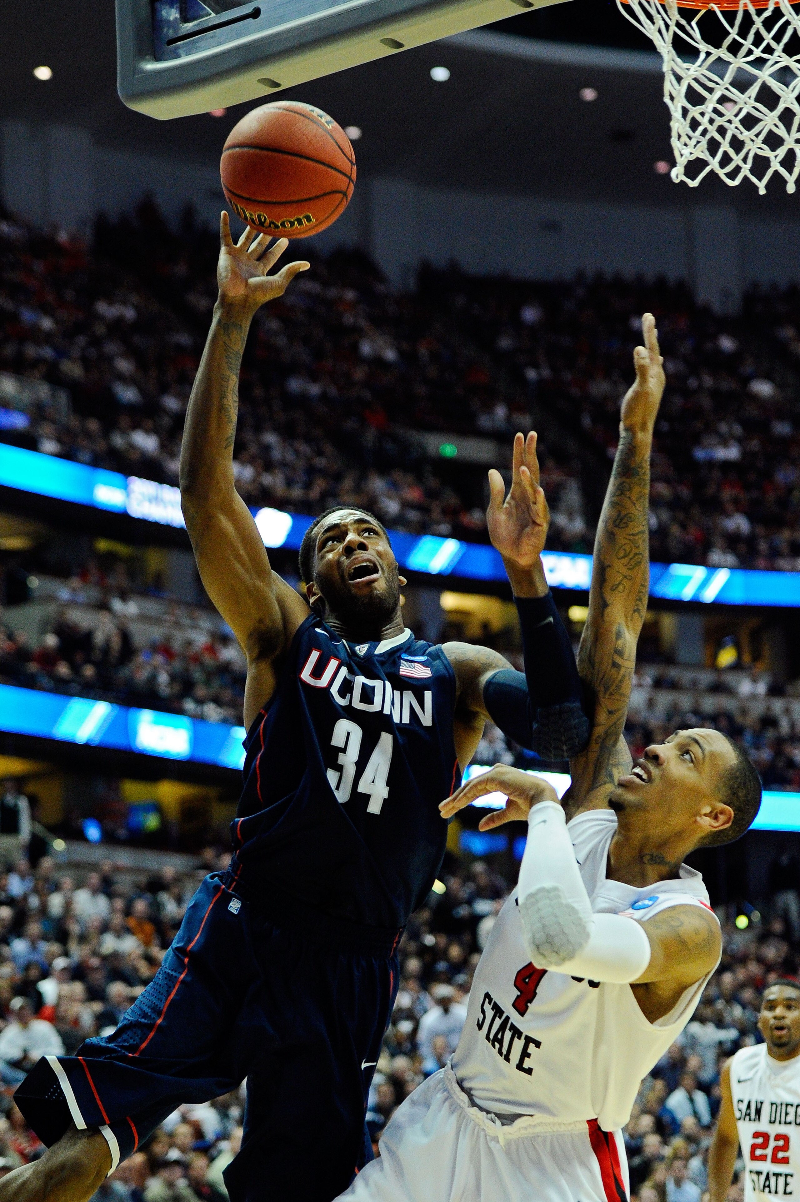 ANAHEIM, CA - MARCH 24:  Alex Oriakhi #34 of the Connecticut Huskies drives to the basket against Malcolm Thomas #4 of the San Diego State Aztecs during the west regional semifinal of the 2011 NCAA men's basketball tournament at the Honda Center on March