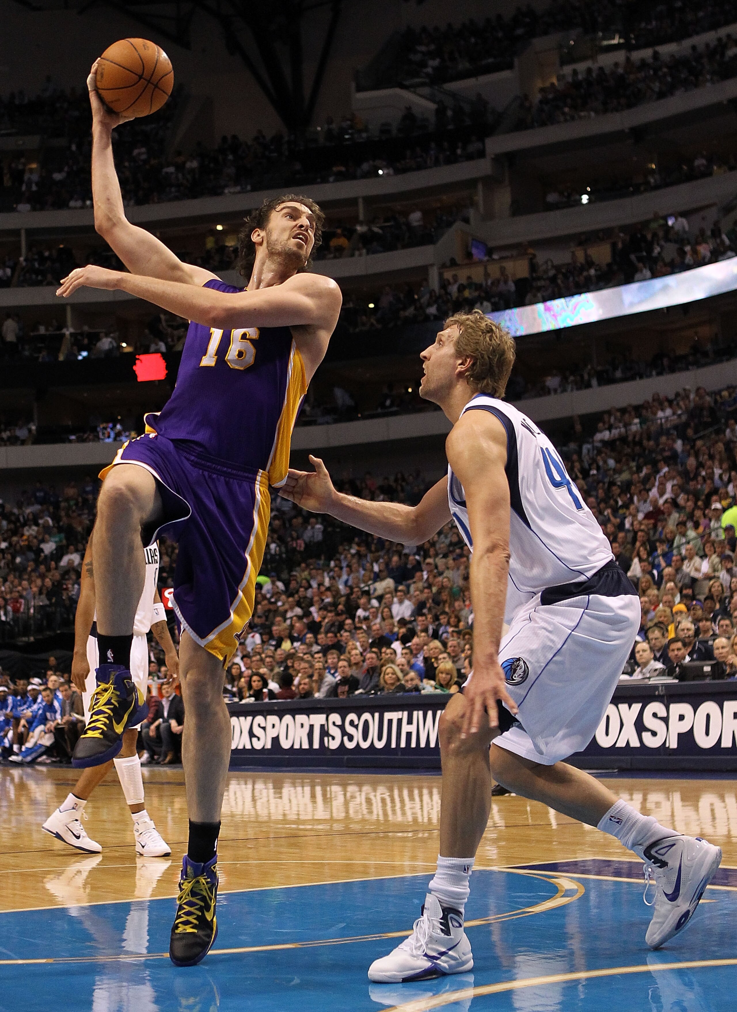DALLAS, TX - MARCH 12:  Forward Pau Gasol #16 of the Los Angeles Lakers takes a shot against Dirk Nowitzki #41 of the Dallas Mavericks at American Airlines Center on March 12, 2011 in Dallas, Texas.  NOTE TO USER: User expressly acknowledges and agrees th
