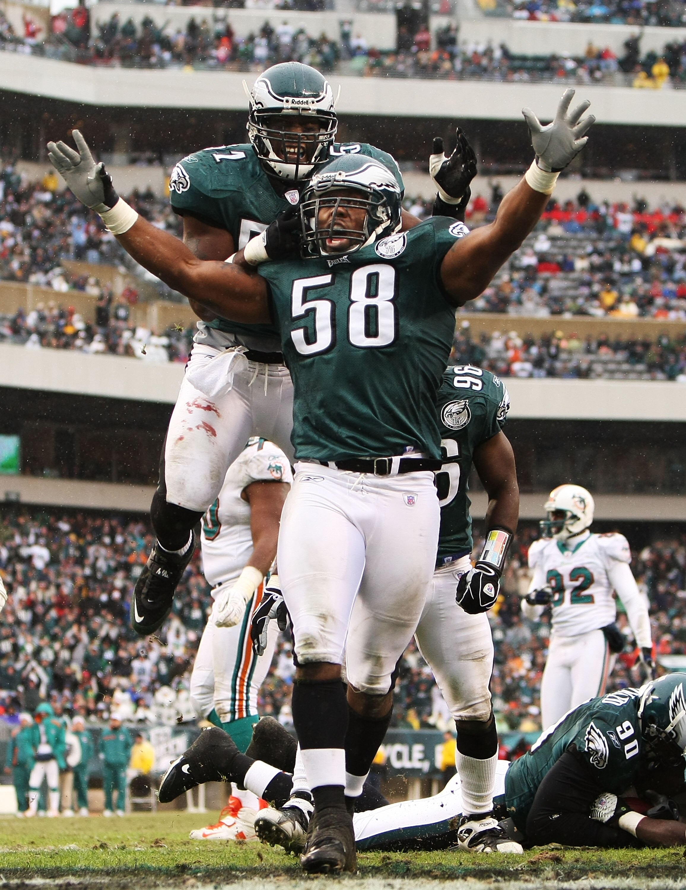 PHILADELPHIA - NOVEMBER 18:  Trent Cole #58 and Pago Togafau #52 of the Philadelphia Eagles celebrate a tackle against the Miami Dolphins on November 18, 2007 at Lincoln Financial Field in Philadelphia, Pennsylvania.  (Photo by Al Bello/Getty Images)