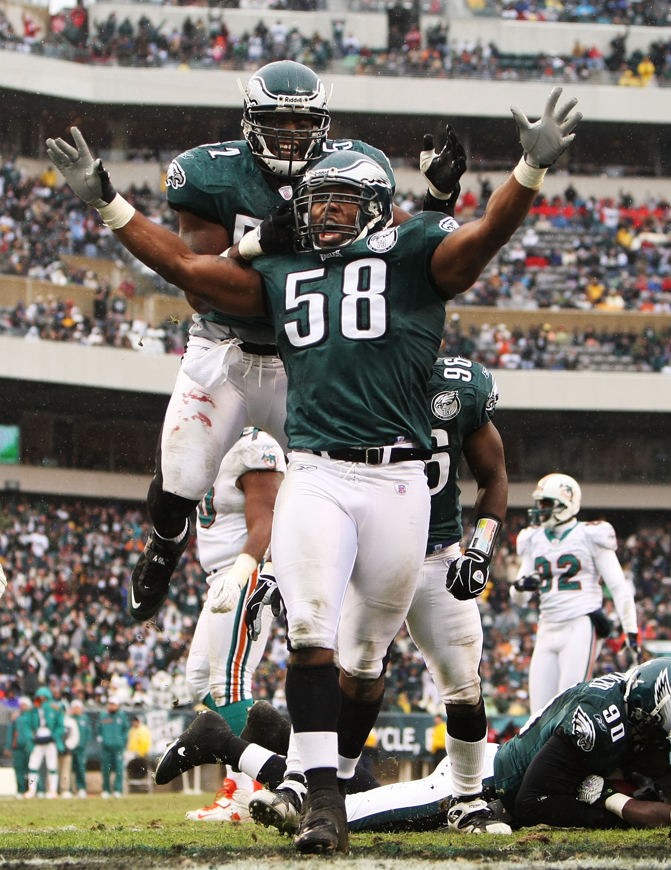 PHILADELPHIA - NOVEMBER 18:  Trent Cole #58 and Pago Togafau #52 of the Philadelphia Eagles celebrate a tackle against the Miami Dolphins on November 18, 2007 at Lincoln Financial Field in Philadelphia, Pennsylvania.  (Photo by Al Bello/Getty Images)
