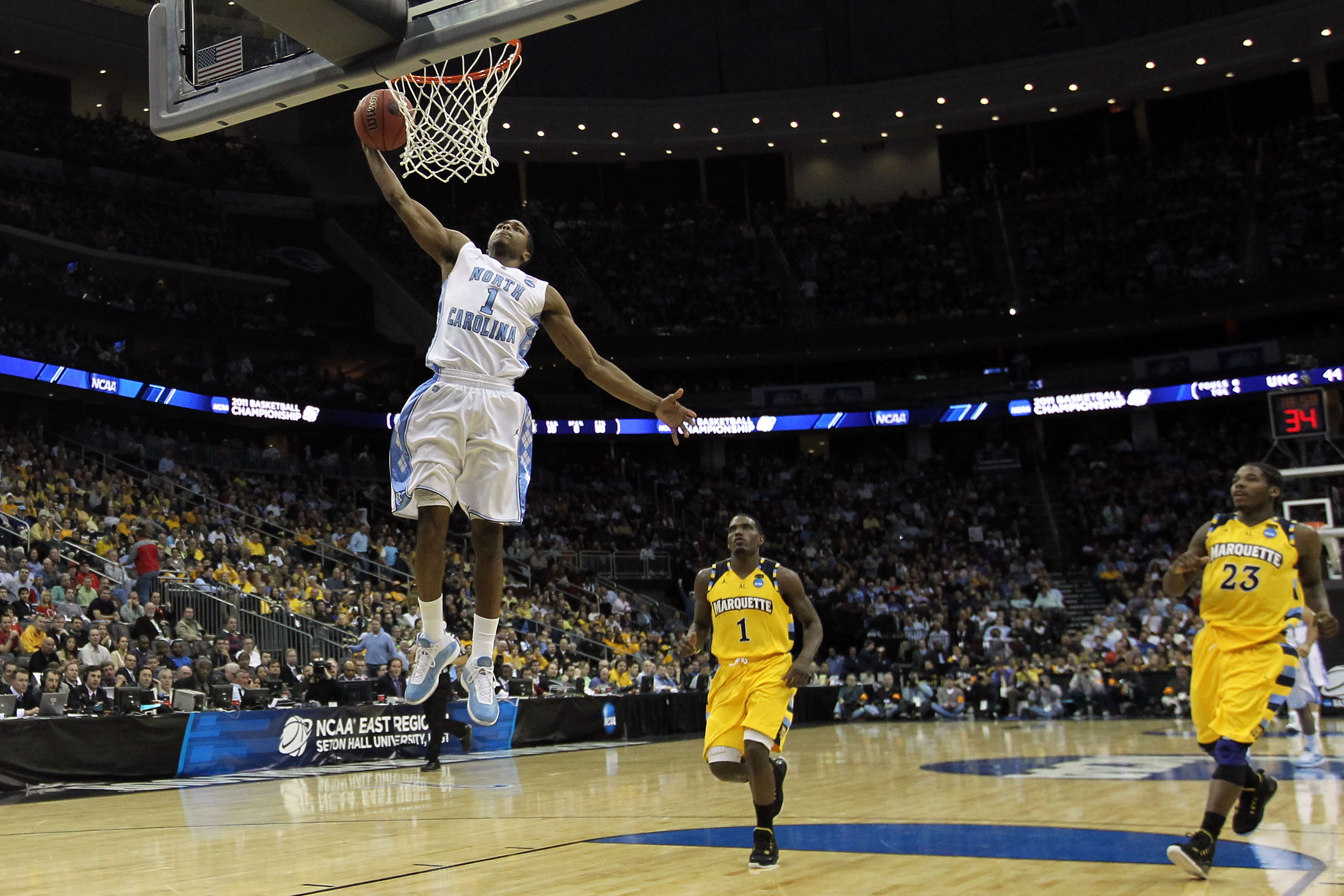 NEWARK, NJ - MARCH 25:  Dexter Strickland #1 of the North Carolina Tar Heels dunks the ball against Darius Johnson-Odom #1 of the Marquette Golden Eagles during the second half of the east regional semifinal of the 2011 NCAA Men's Basketball Tournament at