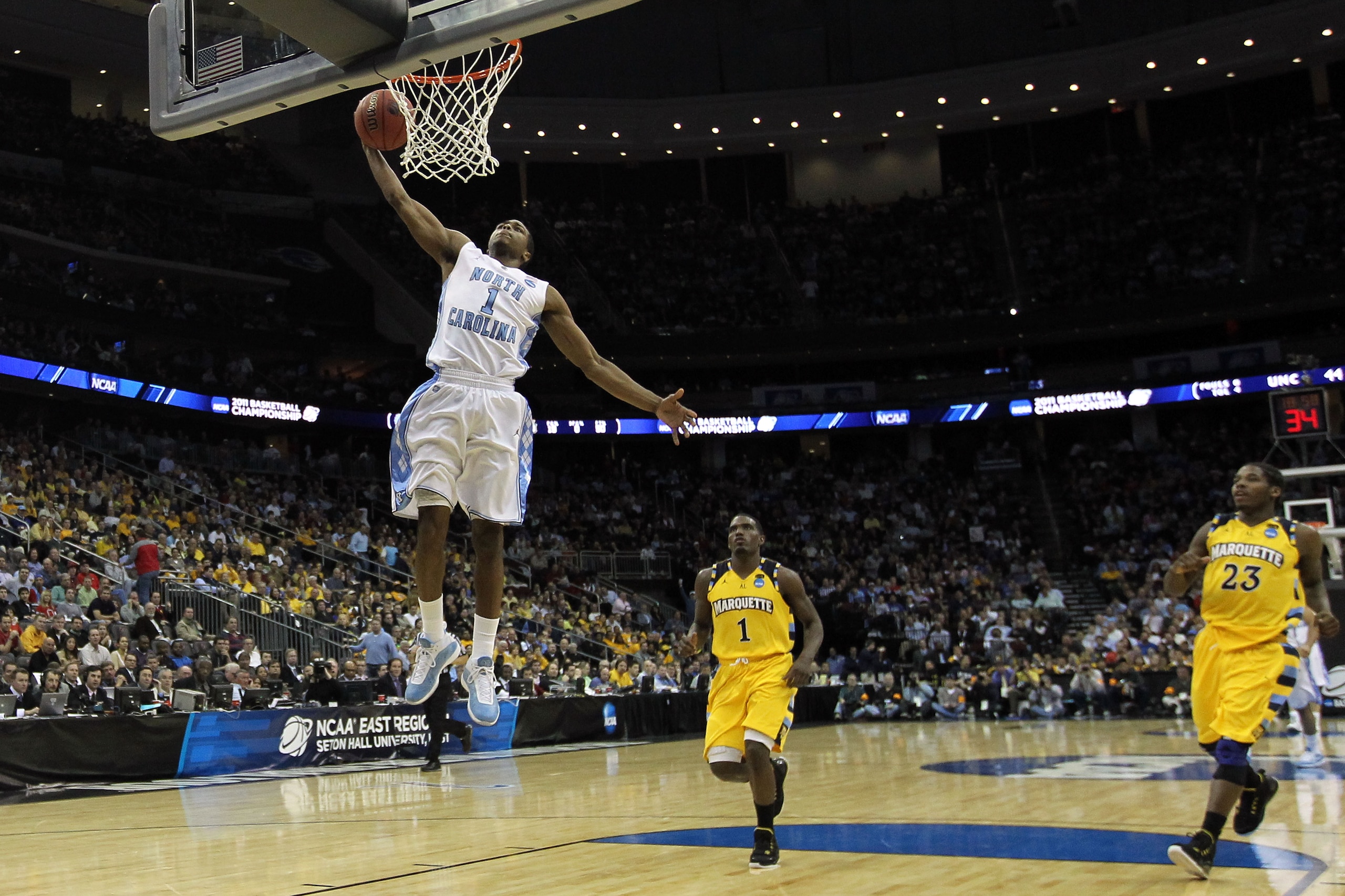 NEWARK, NJ - MARCH 25: Dexter Strickland #1 of the North Carolina Tar Heels dunks the ball against Darius Johnson-Odom #1 of the Marquette Golden Eagles during the second half of the east regional semifinal of the 2011 NCAA Men's Basketball Tournament at NEWARK, NJ - MARCH 25: Dexter Strickland #1 of the North Carolina Tar Heels dunks the ball against Darius Johnson-Odom #1 of the Marquette Golden Eagles during the second half of the east regional semifinal of the 2011 NCAA Men's Basketball Tournament at