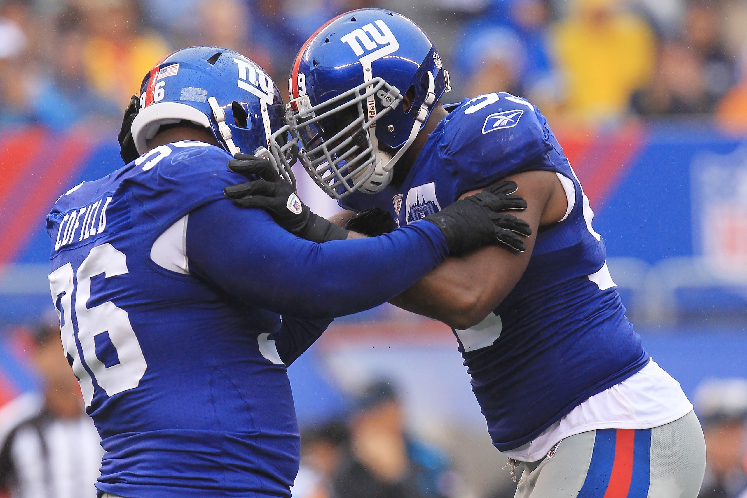 EAST RUTHERFORD, NJ - SEPTEMBER 12: Barry Cofield #96 of the New York Giants celebrates with team mate Chris Canty #99 after sacking Matt Moore #3 of the Carolina Panthers during the NFL season opener at New Meadowlands Stadium on September 12, 2010 in Ea
