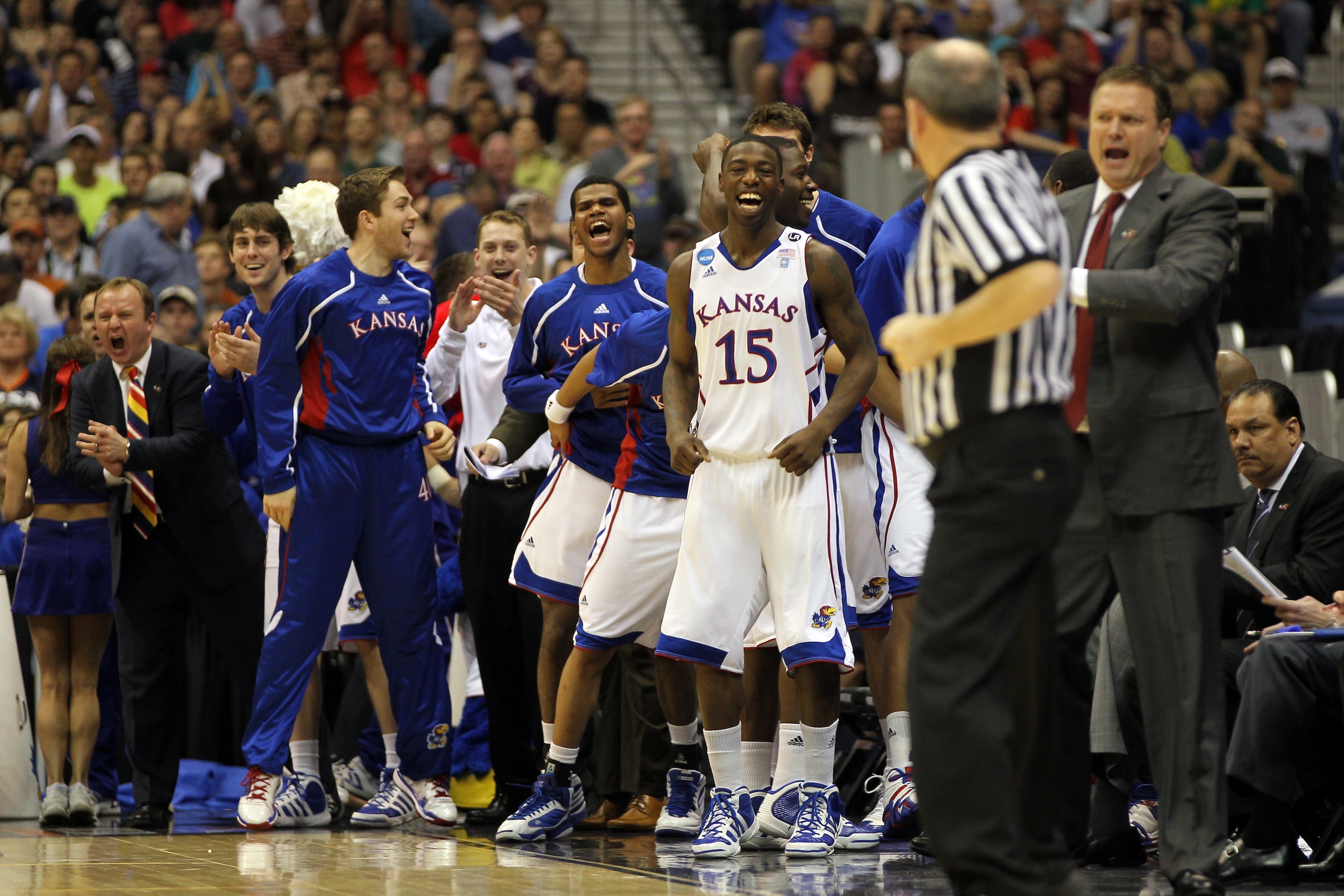 SAN ANTONIO, TX - MARCH 25:  Elijah Johnson #15 of the Kansas Jayhawks celebrates from the bench during the southwest regional of the 2011 NCAA men's basketball tournament against the Richmond Spiders at the Alamodome on March 25, 2011 in San Antonio, Tex