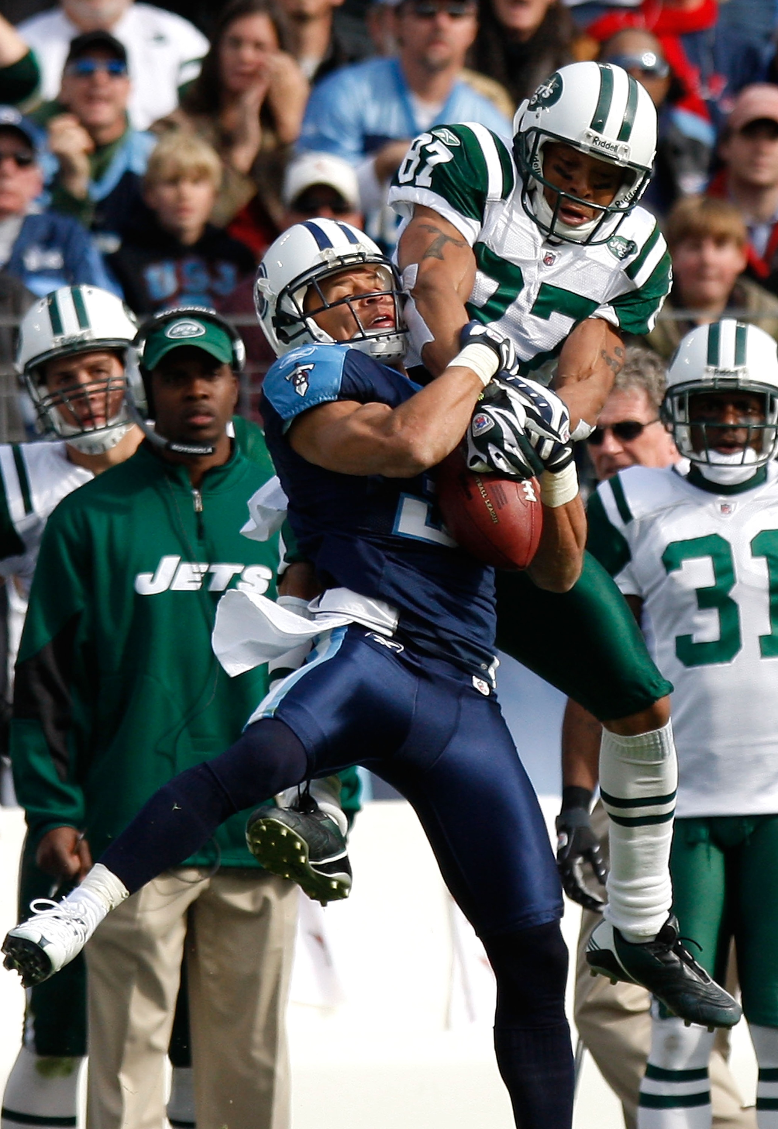 NASHVILLE, TN - NOVEMBER 23:  Cortland Finnegan #31 of the Tennessee Titans intercepts this pass intended for Laveranues Coles #87 of the New York Jets during the game at LP Field on November 23, 2008 in Nashville, Tennessee.  (Photo by Kevin C. Cox/Getty