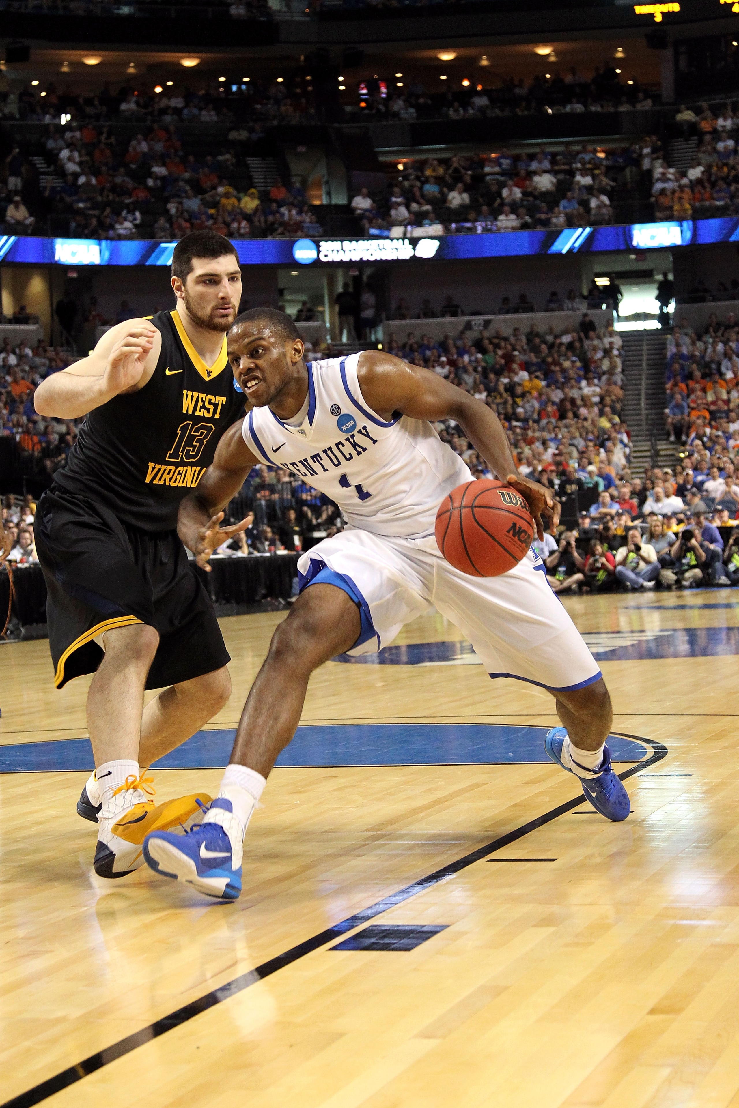 TAMPA, FL - MARCH 19: Darius Miller #1 of the Kentucky Wildcats drives against Deniz Kilicli #13 of the West Virginia Mountaineers during the third round of the 2011 NCAA men's basketball tournament at St. Pete Times Forum on March 19, 2011 in Tampa, Flo TAMPA, FL - MARCH 19: Darius Miller #1 of the Kentucky Wildcats drives against Deniz Kilicli #13 of the West Virginia Mountaineers during the third round of the 2011 NCAA men's basketball tournament at St. Pete Times Forum on March 19, 2011 in Tampa, Flo