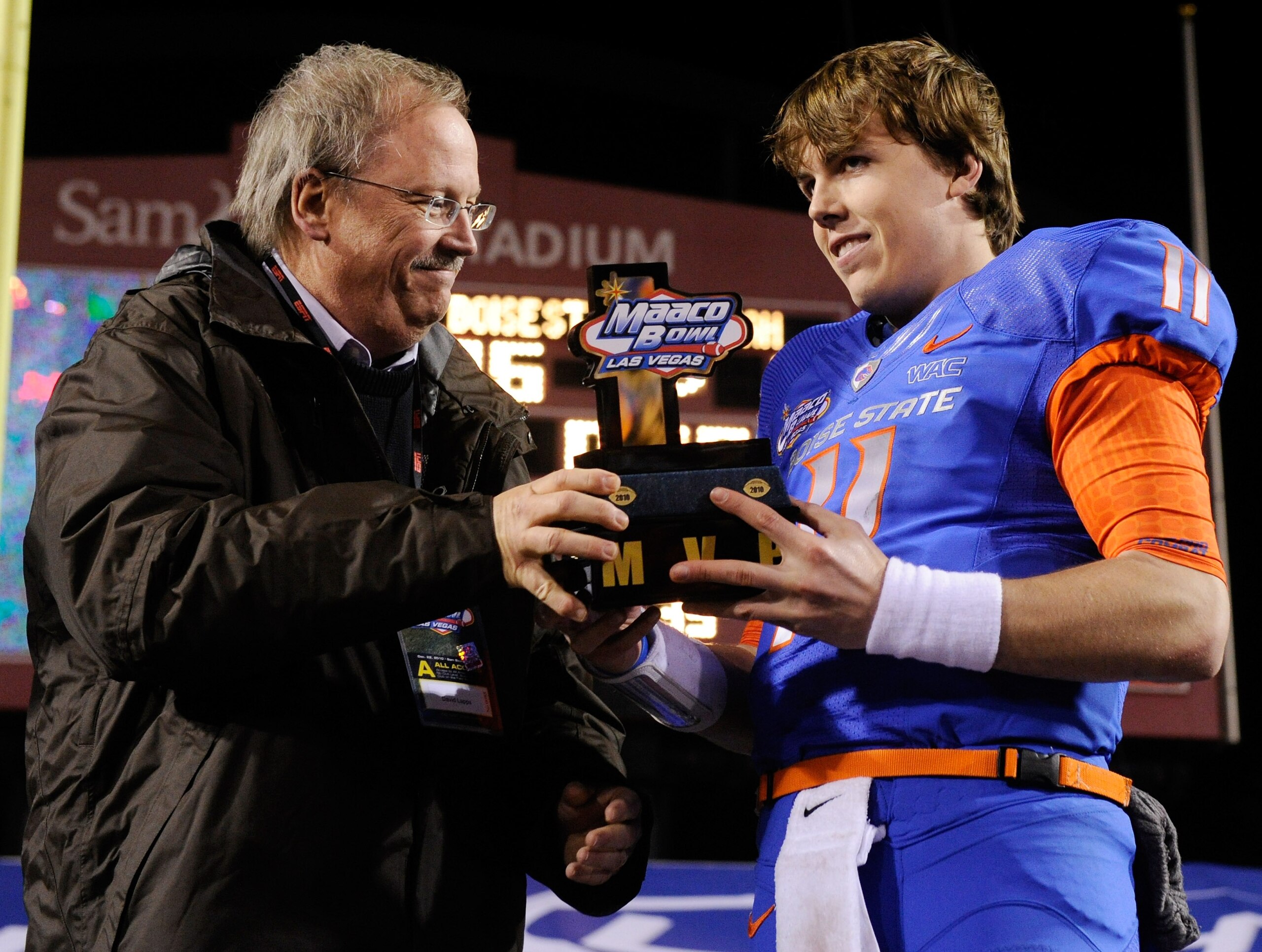 LAS VEGAS, NV - DECEMBER 22: MAACO President Dave Lapps (L) gives the most valuable player trophy to quarterback Kellen Moore #11 of the Boise State Broncos after the team's 26-3 victory over the Utah Utes in the MAACO Bowl Las Vegas at Sam Boyd Stadium LAS VEGAS, NV - DECEMBER 22: MAACO President Dave Lapps (L) gives the most valuable player trophy to quarterback Kellen Moore #11 of the Boise State Broncos after the team's 26-3 victory over the Utah Utes in the MAACO Bowl Las Vegas at Sam Boyd Stadium