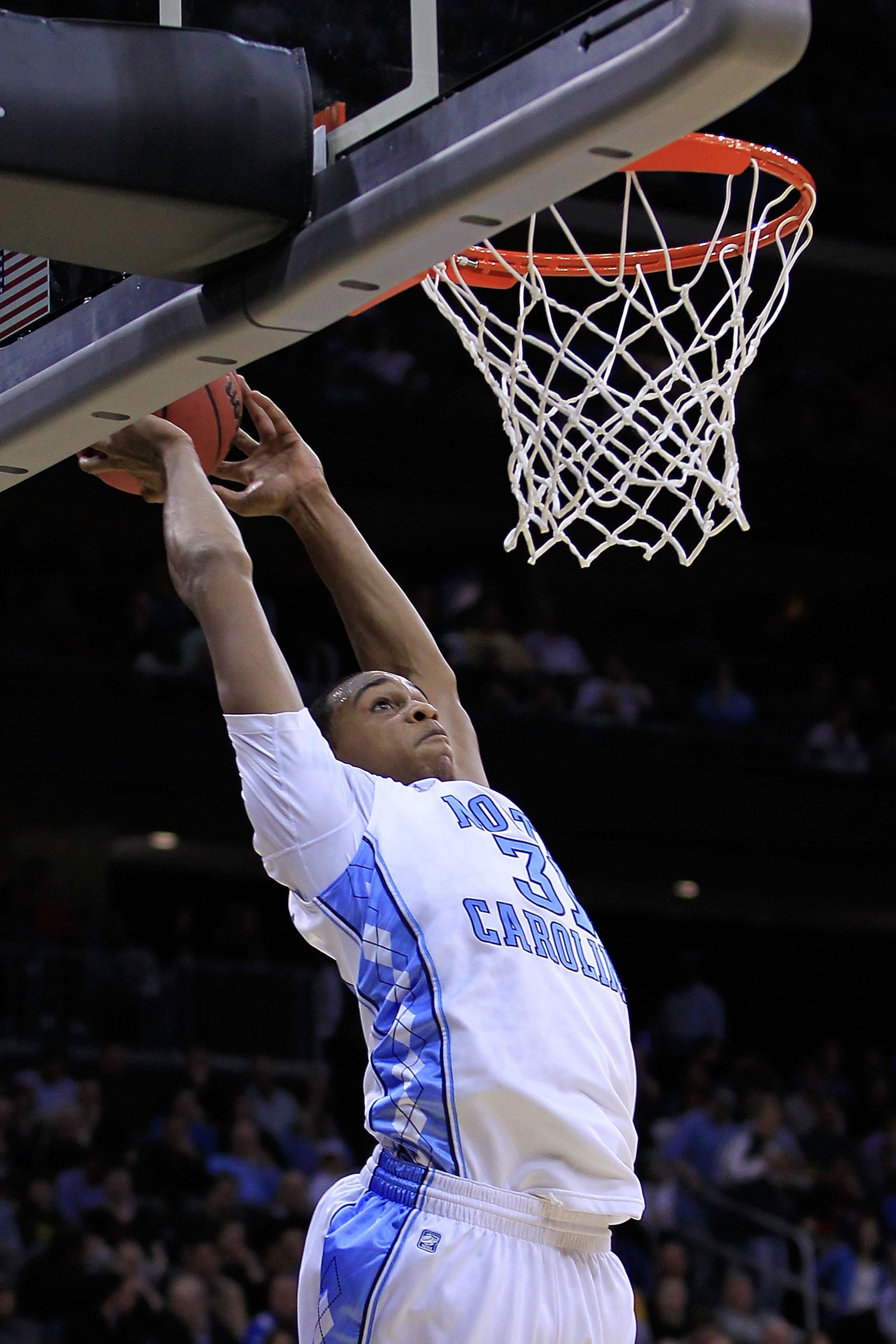 NEWARK, NJ - MARCH 25: John Henson #31 of the North Carolina Tar Heels goes for a dunk against the Marquette Golden Eagles during the east regional semifinal of the 2011 NCAA Men's Basketball Tournament at the Prudential Center on March 25, 2011 in Newar NEWARK, NJ - MARCH 25: John Henson #31 of the North Carolina Tar Heels goes for a dunk against the Marquette Golden Eagles during the east regional semifinal of the 2011 NCAA Men's Basketball Tournament at the Prudential Center on March 25, 2011 in Newar
