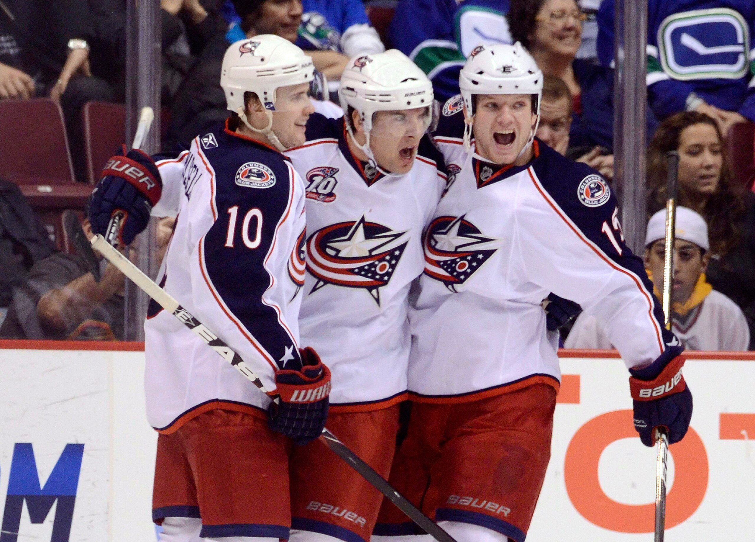 VANCOUVER, CANADA - MARCH 1: Scottie Upshall #8 of the Columbus Blue Jackets celebrates with Kris Russell #10 and Derek Dorsett #15 after scoring against the Vancouver Canucks during the second period in NHL action on March 01, 2011 at Rogers Arena in Van